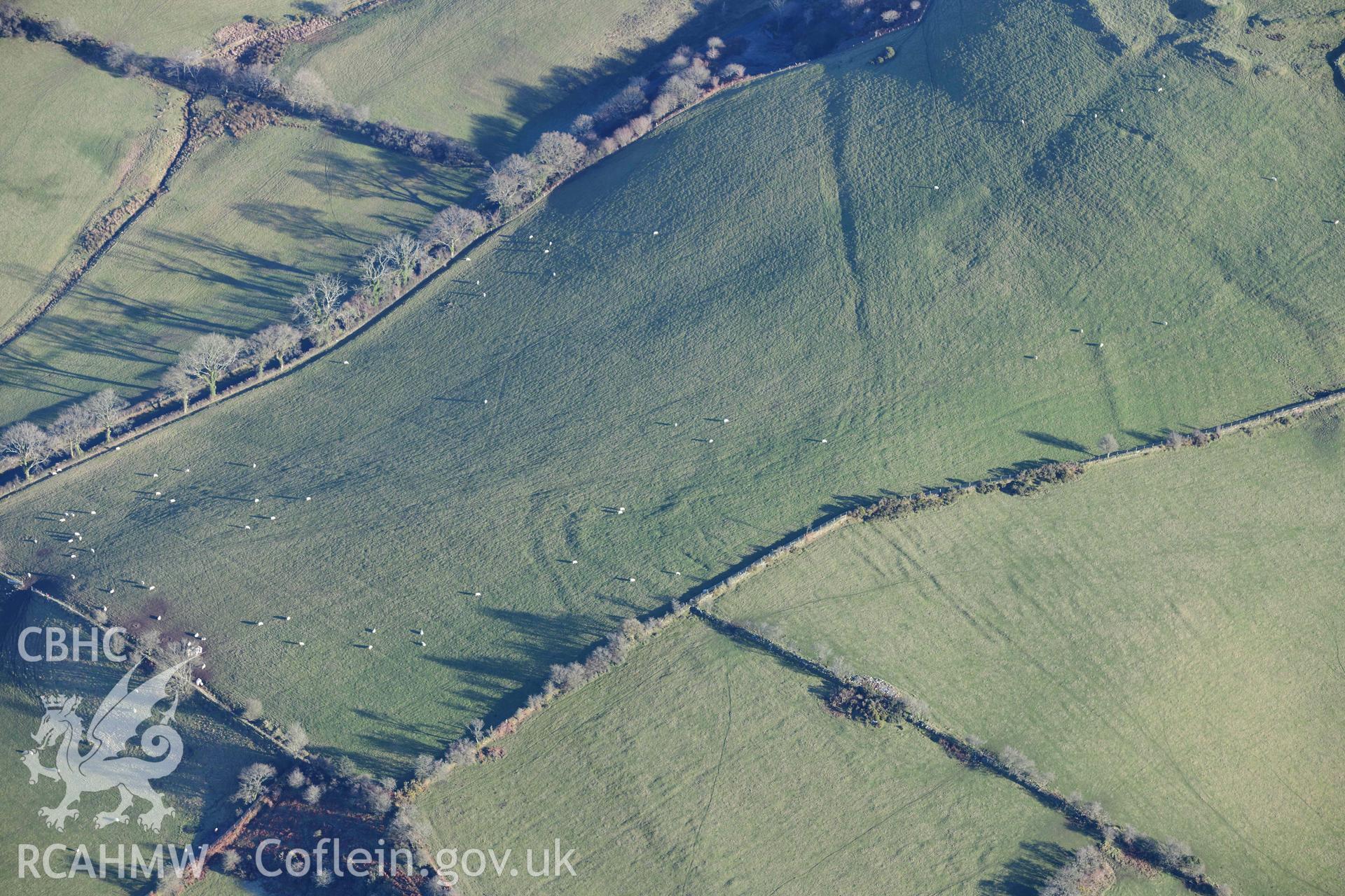 Oblique aerial photograph showing detail of prehistoric earthworks at SN525591, Castell Perthi Mawr. Taken during the Royal Commission’s programme of archaeological aerial reconnaissance by Toby Driver on 17th January 2022