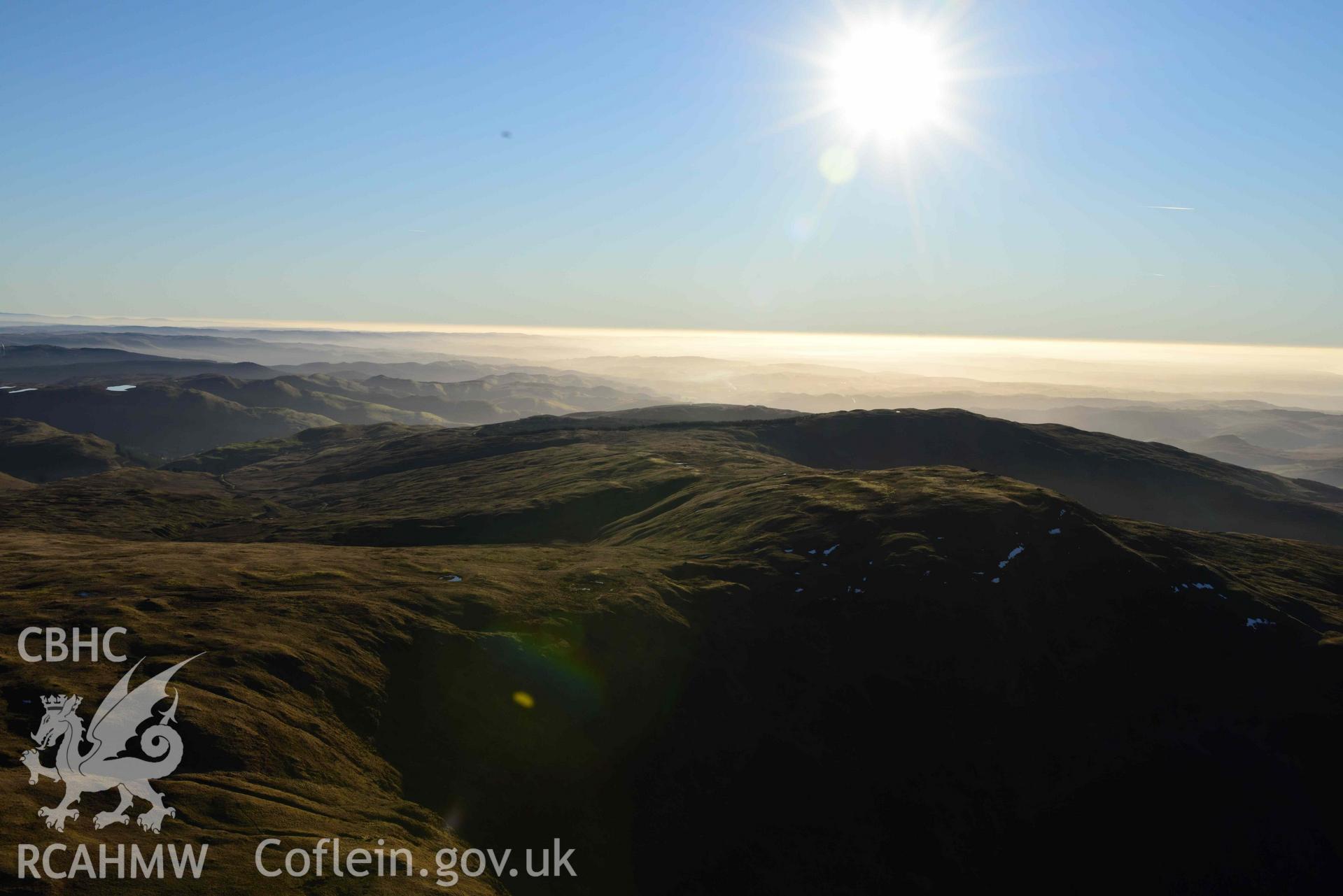 Oblique aerial photograph showing wide view from the north east of Pen Plynlimon Fawr cairn cemetery. Taken during the Royal Commission’s programme of archaeological aerial reconnaissance by Toby Driver on 17th January 2022