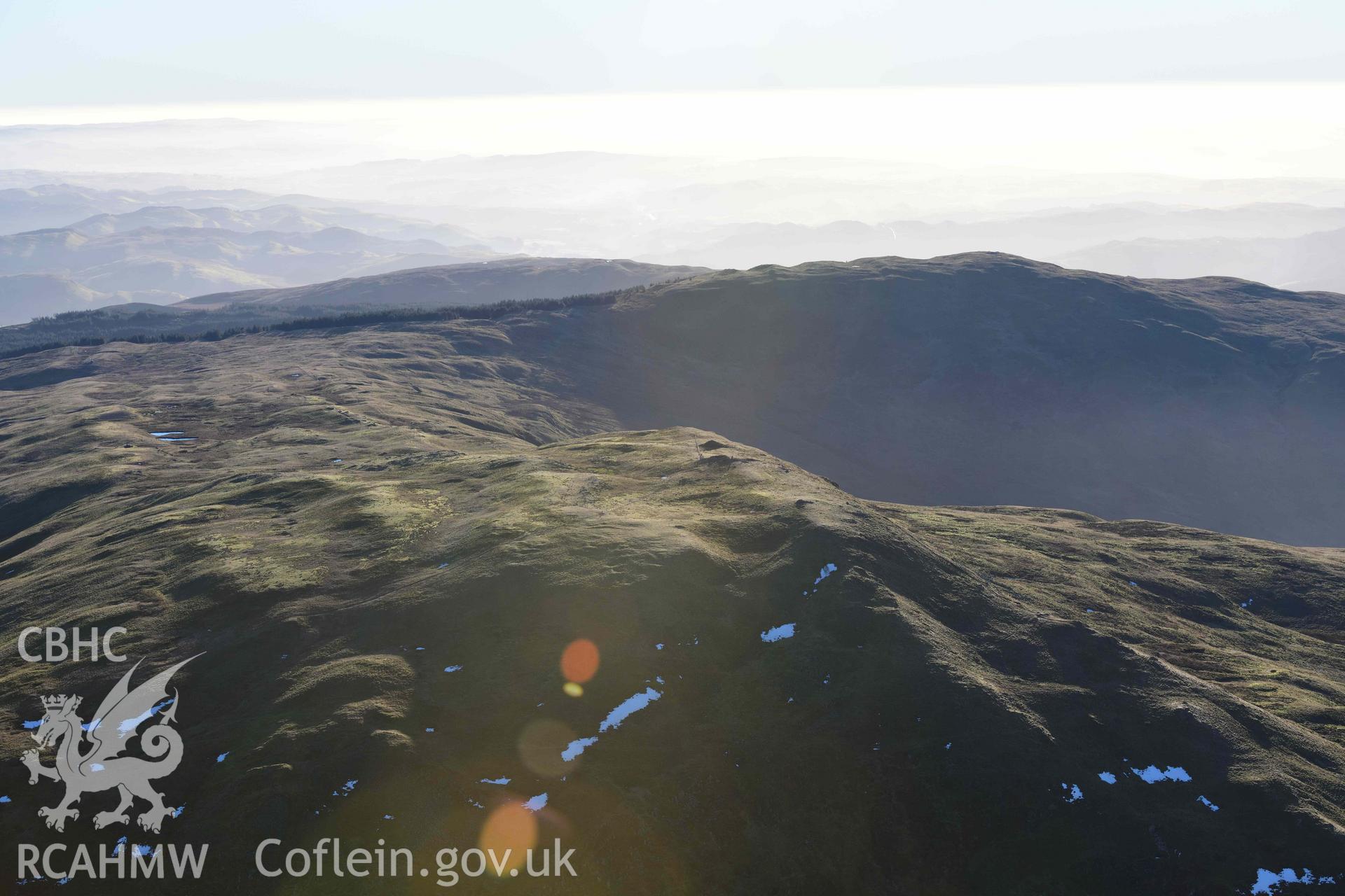 Oblique aerial photograph showing view from the north of Pen Plynlimon Fawr cairn cemetery. Taken during the Royal Commission’s programme of archaeological aerial reconnaissance by Toby Driver on 17th January 2022