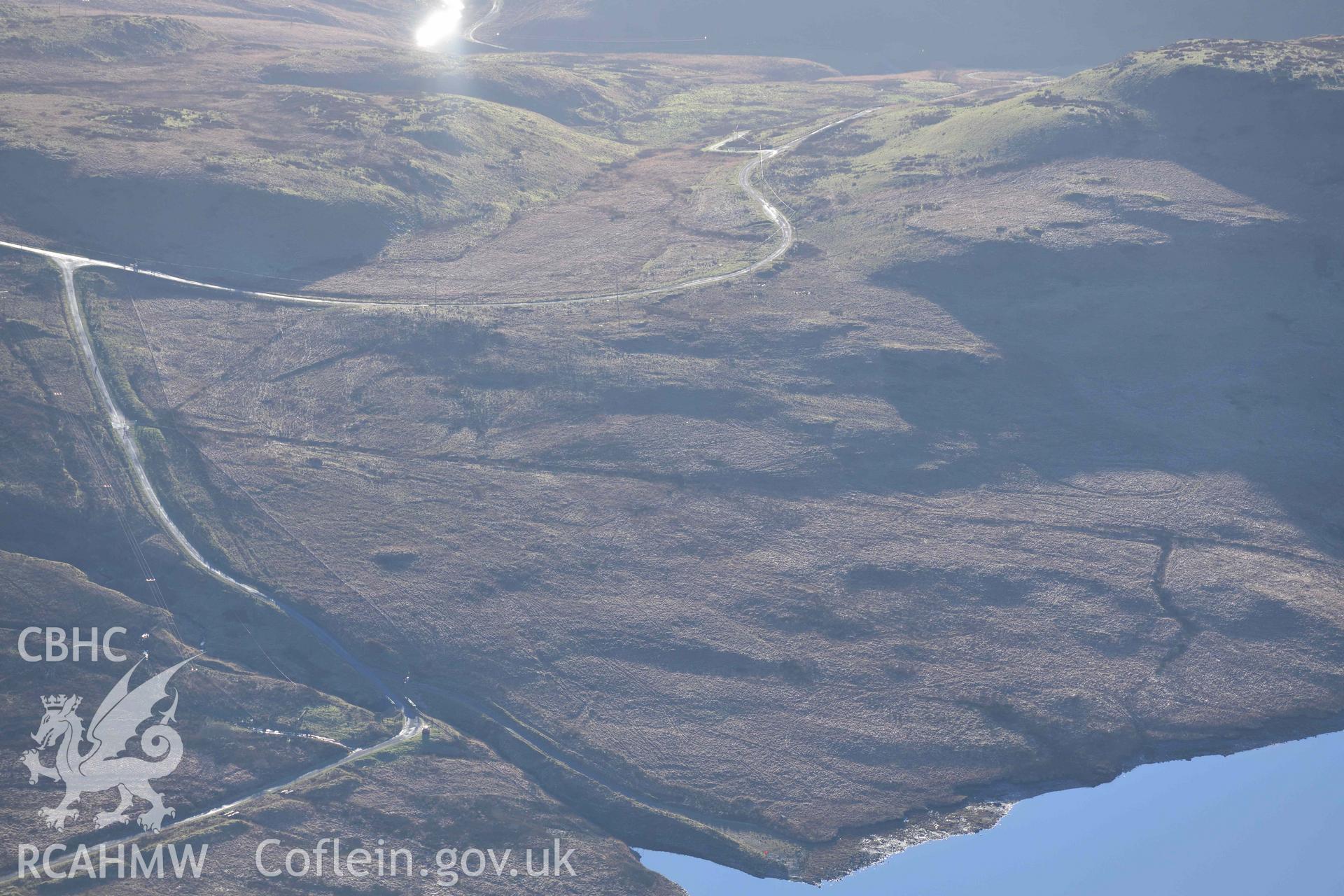 Oblique aerial photograph showing view from the north east of Nant Maesnant cairn. Taken during the Royal Commission’s programme of archaeological aerial reconnaissance by Toby Driver on 17th January 2022