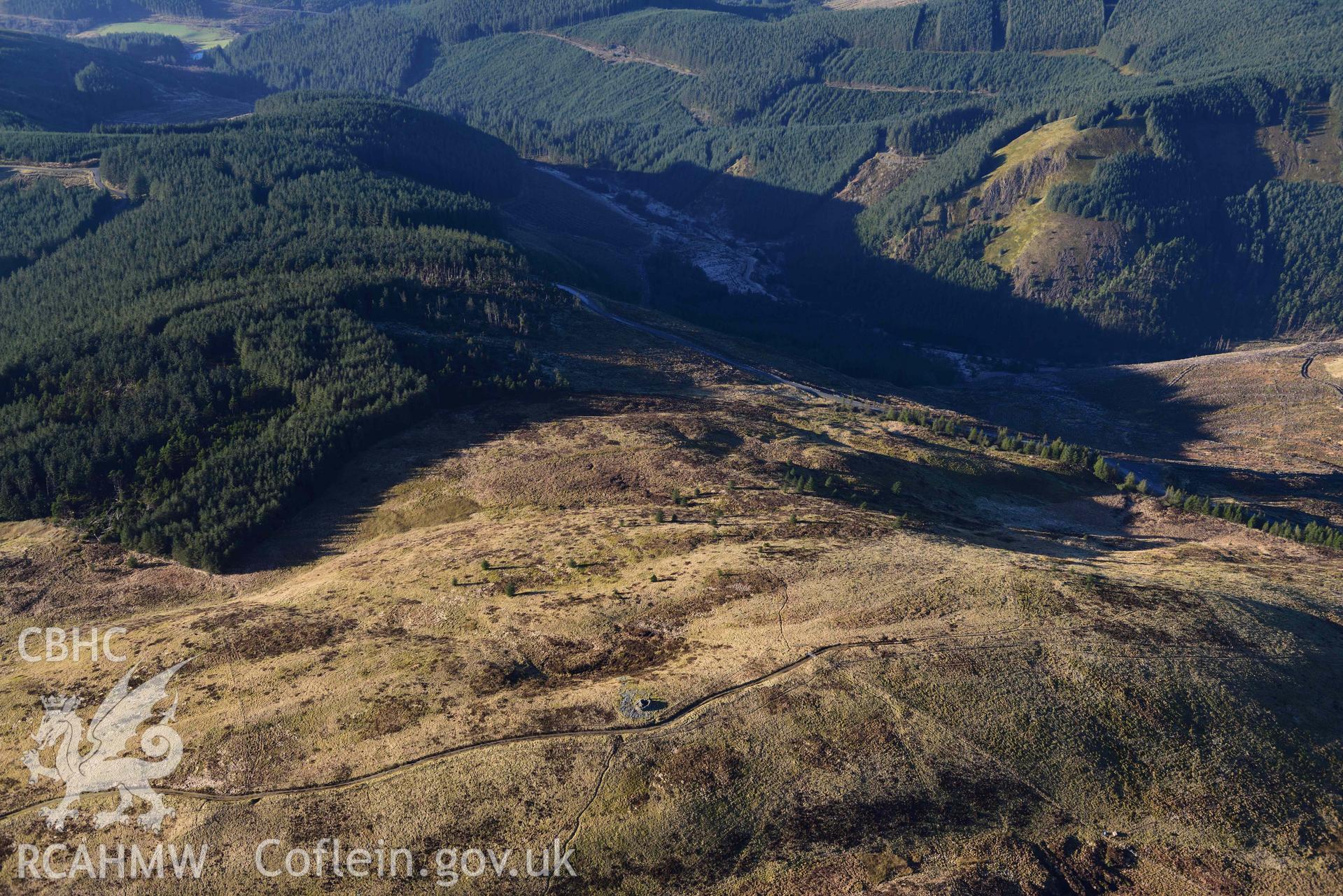 Oblique aerial photograph of Pen y Garn round cairn taken during the Royal Commission’s programme of archaeological aerial reconnaissance by Toby Driver on 17th January 2022