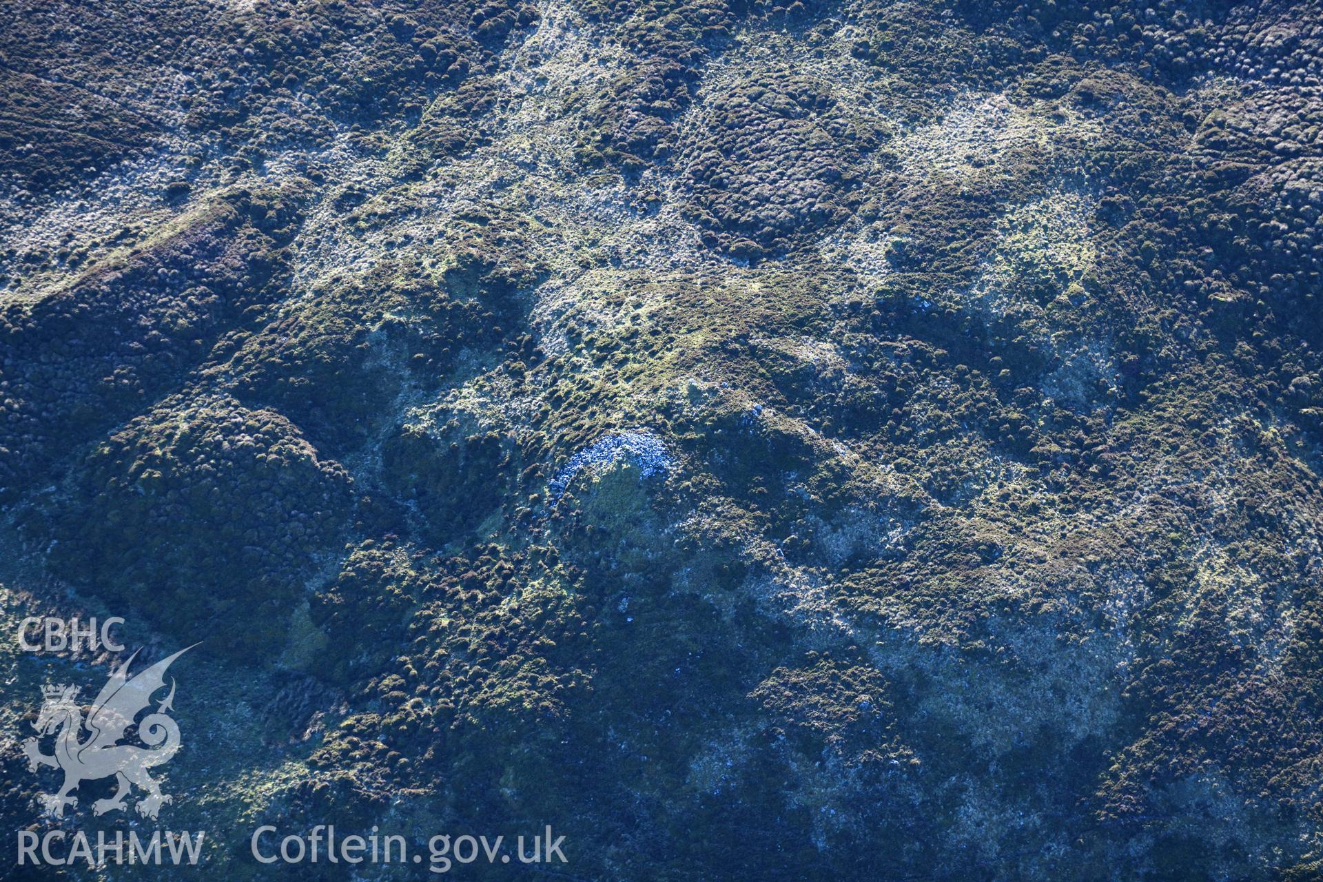 Oblique aerial photograph of outlying cairn at Cairn Biga cairn taken during the Royal Commission’s programme of archaeological aerial reconnaissance by Toby Driver on 17th January 2022