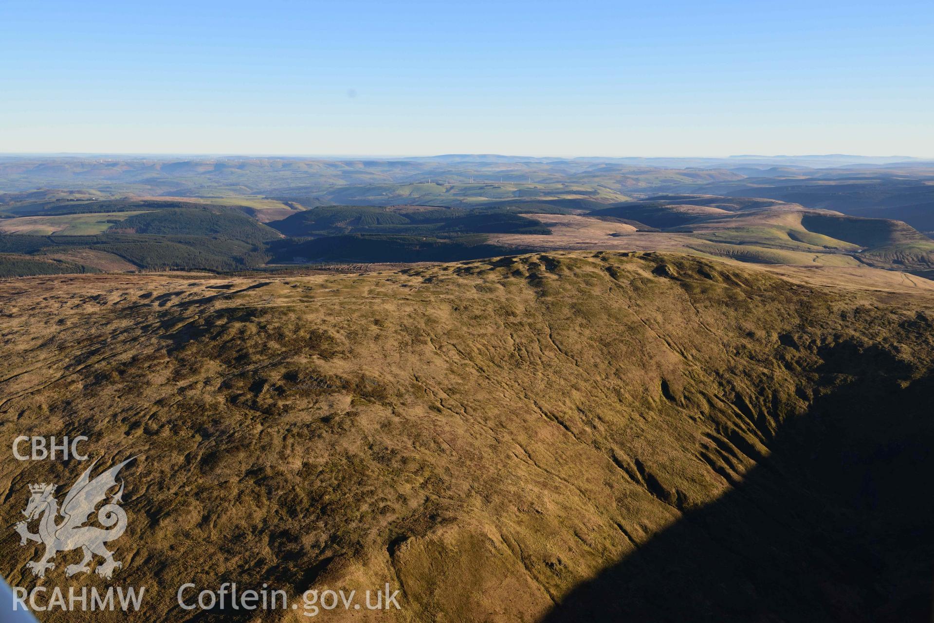 Oblique aerial photograph showing wide view from the north west of Pen Pumlumon Arwystli cairn cemetery. Taken during the Royal Commission’s programme of archaeological aerial reconnaissance by Toby Driver on 17th January 2022