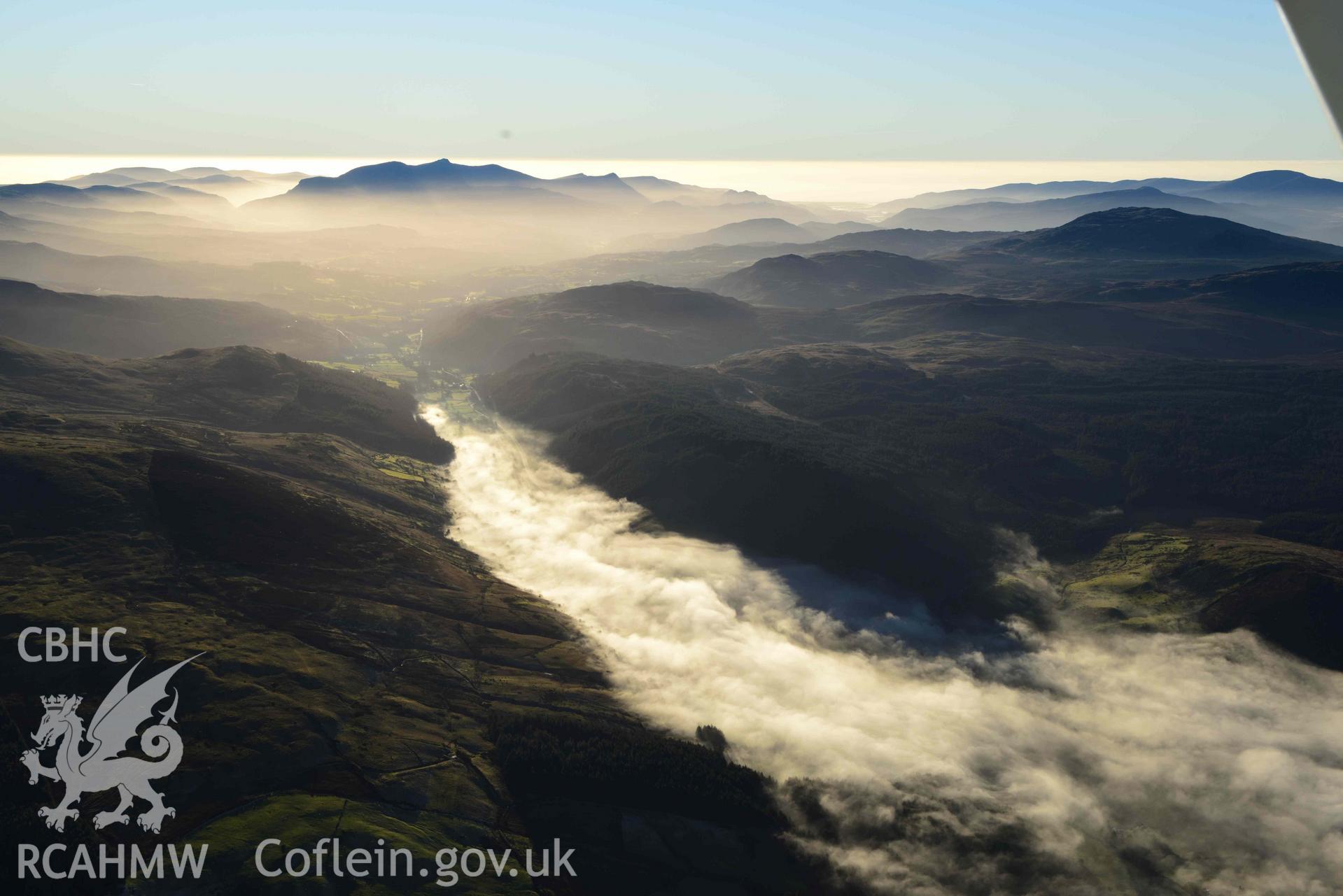 Oblique aerial photograph of Cader Idris winter landscape with cloud inversion at Llanuwchllyn. Taken from the north east during the Royal Commission’s programme of archaeological aerial reconnaissance by Toby Driver on 17th January 2022