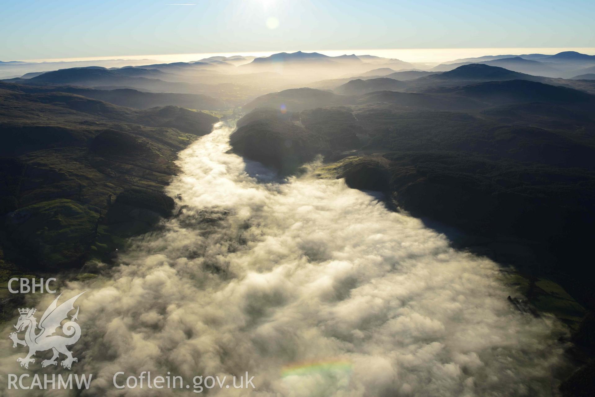 Oblique aerial photograph of Cader Idris winter landscape with cloud inversion at Llanuwchllyn. Taken from the north east during the Royal Commission’s programme of archaeological aerial reconnaissance by Toby Driver on 17th January 2022