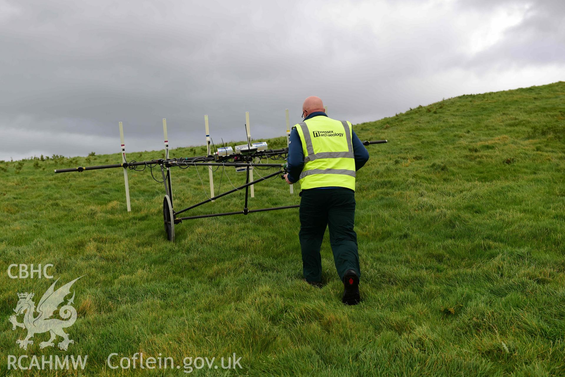 Photograph of survey in progress to south-west of hillfort. Taken by Toby Driver of RCAHMW on 20 October 2020 during Geophysical Survey of Darren Camp Hillfort, Ceredigion. Commissioned by the RCAHMW and produced by Wessex Archaeology, October - December 2020.