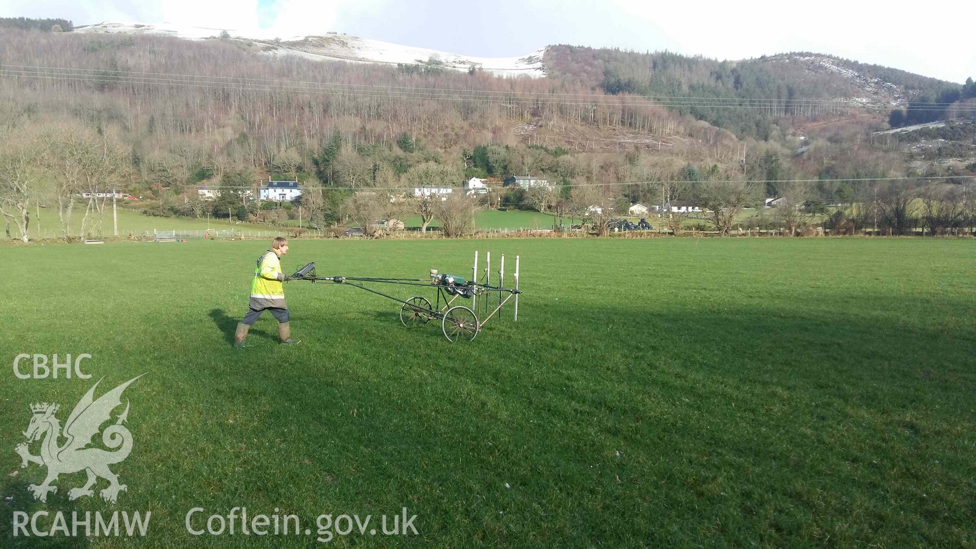 Photograph looking north showing SUMO geophysics survey in progress across barrow cemetery, taken by Sumo Survey on 25 January 2021. Part of Geophysical Survey of Pen y Wal, Dollwen Barrow, Goginan. Commissioned by the RCAHMW and produced by Sumo Survey, 2021.