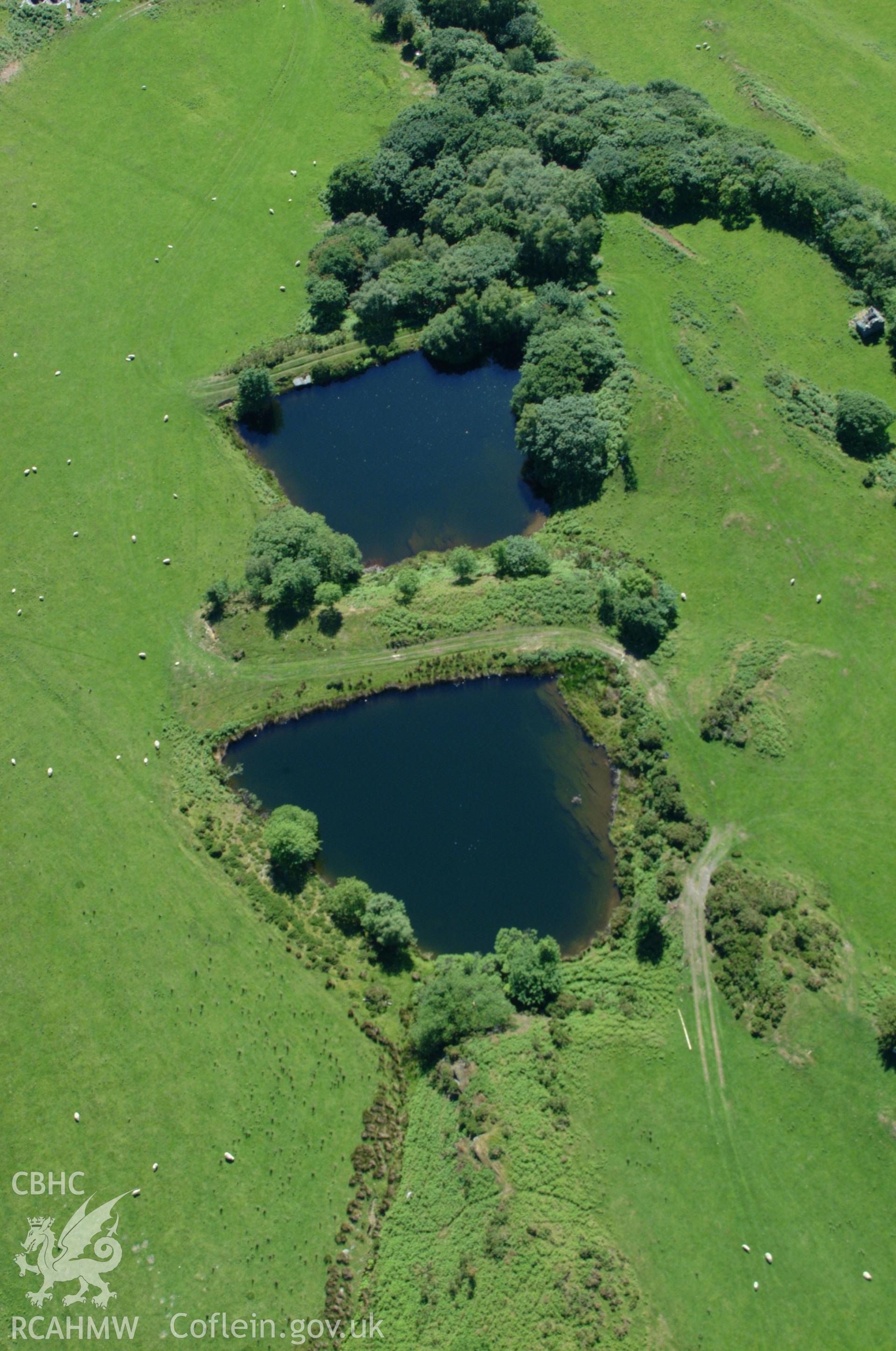 RCAHMW colour oblique aerial photograph of the middle reservoir at Bryndyfi Lead Mine taken on 14/06/2004 by Toby Driver