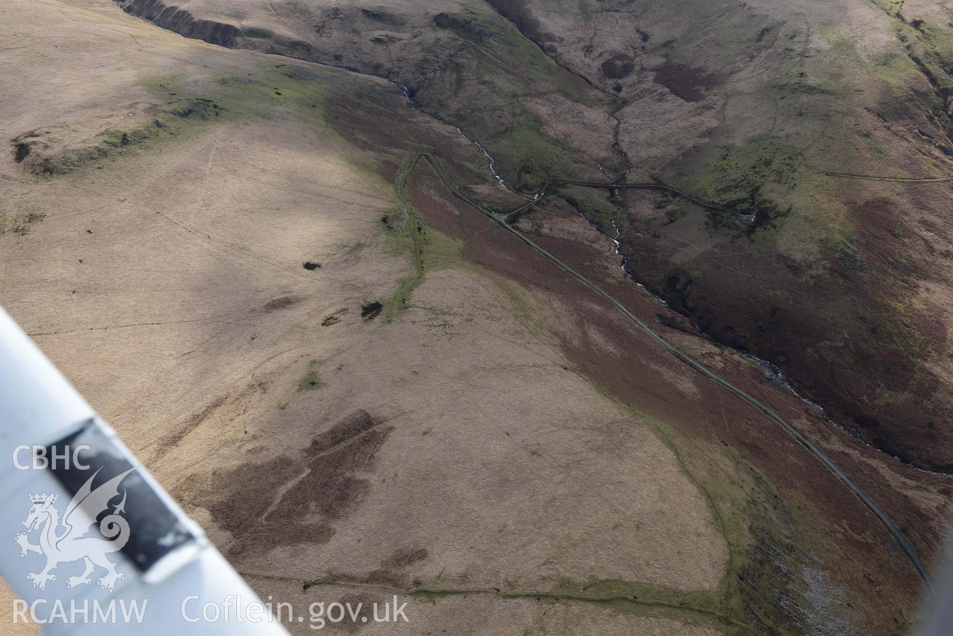 Ring cairn on Esgair Ceiliog, general view from the north. Oblique aerial photograph taken during the Royal Commission’s programme of archaeological aerial reconnaissance by Toby Driver on 14 March 2022.