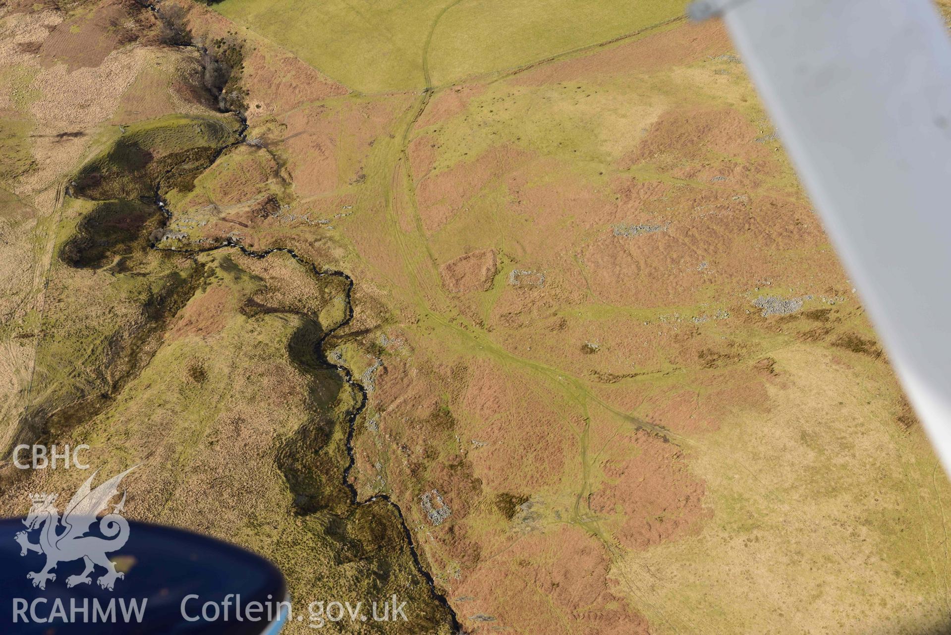 Esgair Gwar y Cae hafotau settlement, Nant Rhyd Goch, from the South East. Oblique aerial photograph taken during the Royal Commission’s programme of archaeological aerial reconnaissance by Toby Driver on 14 March 2022.