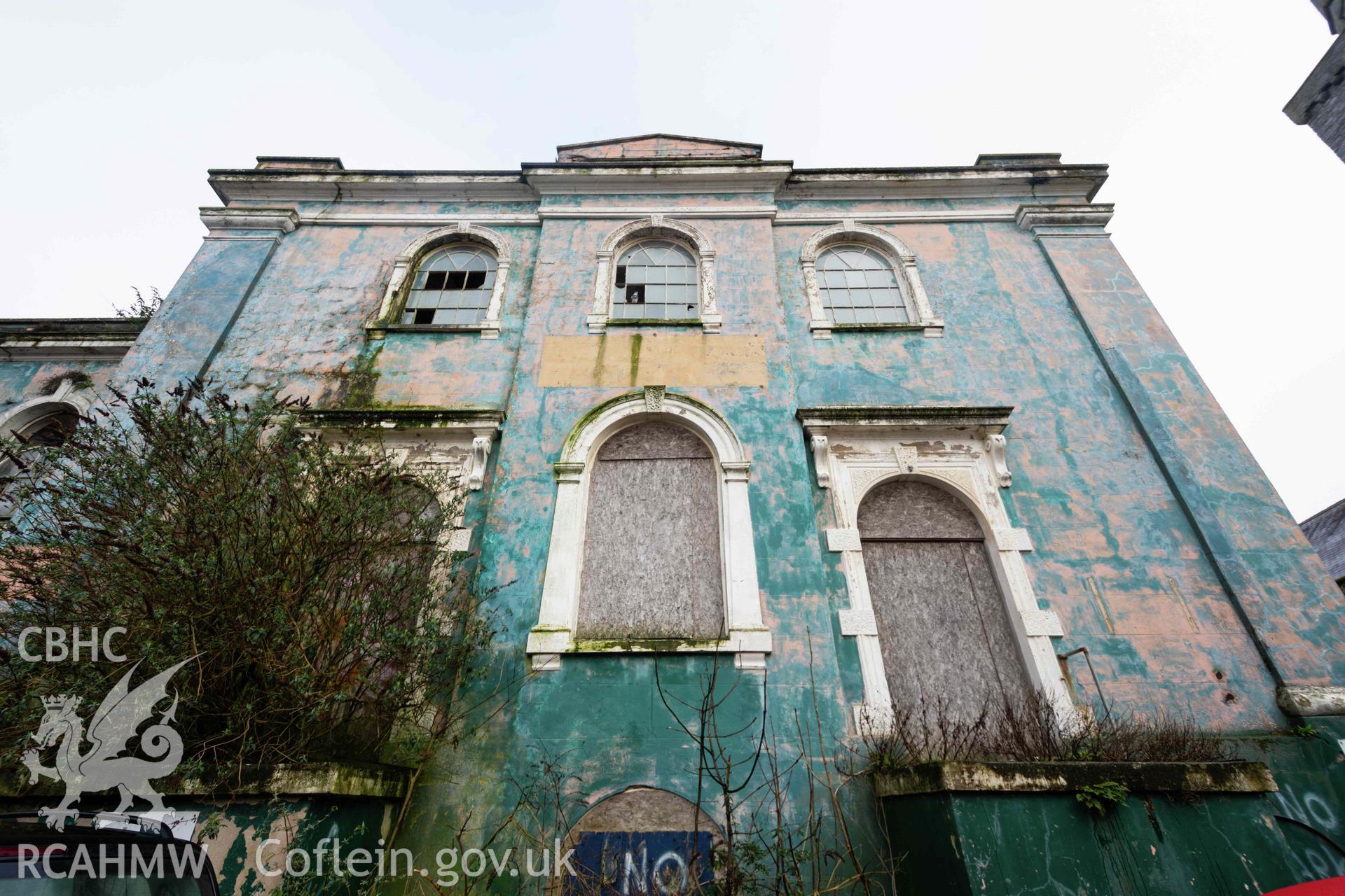 West front façade, north corner. Boarded and smashed windows. Overgrown and derelict. Perrots Road Wesleyan Methodist Chapel, Haverfordwest. Part of a photographic survey conducted by Meilyr Powel on 20 February 2023.