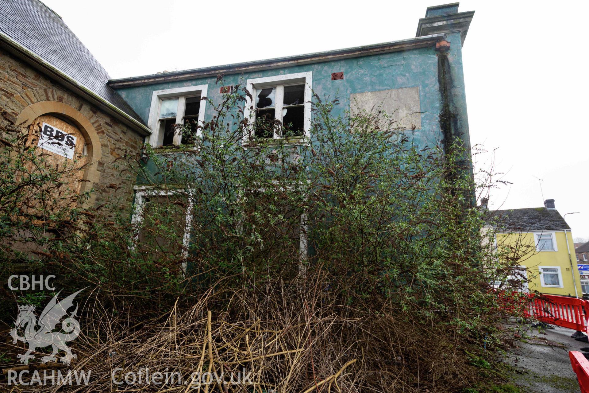 Overgrown north side. Perrots Road Wesleyan Methodist Chapel, Haverfordwest. Part of a photographic survey conducted by Meilyr Powel on 20 February 2023.