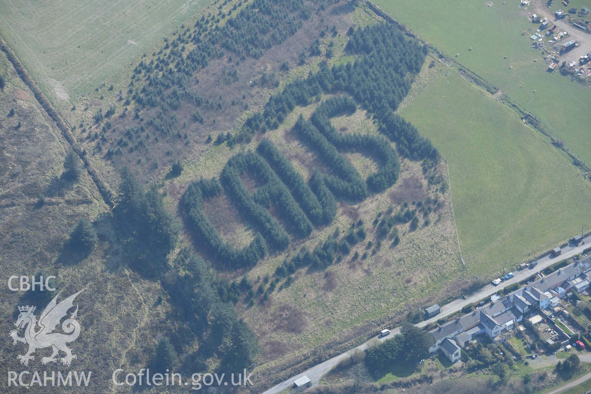 CAWS sign written with trees, Rosebush. Oblique aerial photographs taken during the Royal Commission’s programme of archaeological aerial reconnaissance by Toby Driver on 25 March 2022.