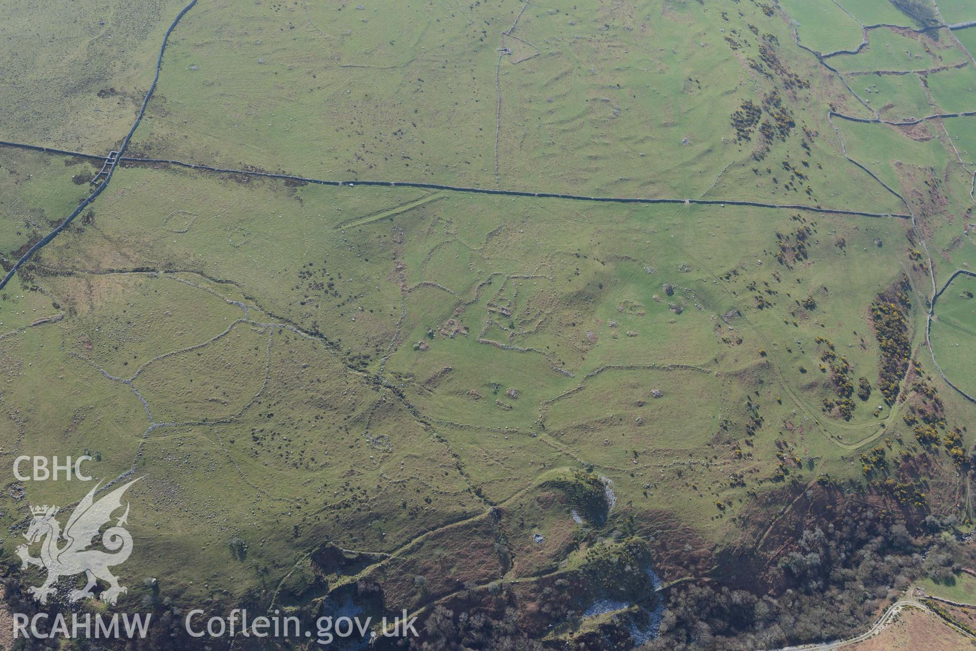 Settlement and fields above Egryn Abbey. Oblique aerial photograph taken during the Royal Commission’s programme of archaeological aerial reconnaissance by Toby Driver on 25 March 2022.