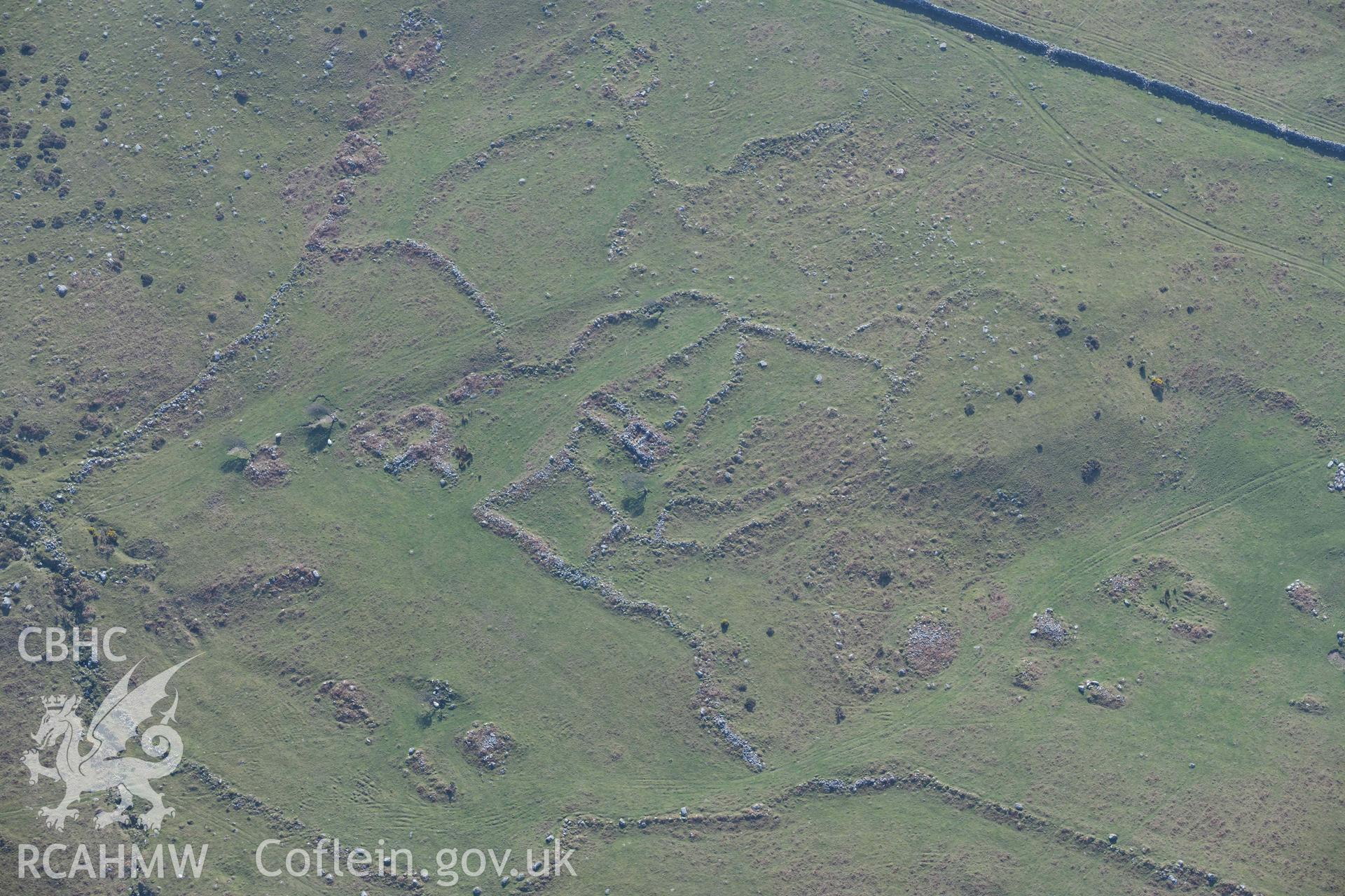 Settlement and fields above Egryn Abbey. Oblique aerial photograph taken during the Royal Commission’s programme of archaeological aerial reconnaissance by Toby Driver on 25 March 2022.