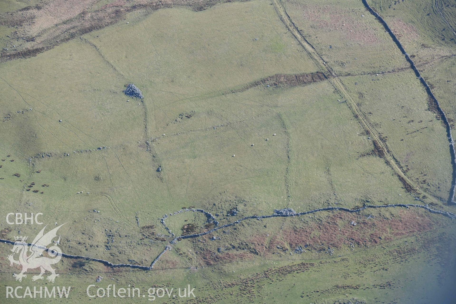 Ffridd Fedw ancient fields and kerb cairn. Oblique aerial photographs taken during the Royal Commission’s programme of archaeological aerial reconnaissance by Toby Driver on 25 March 2022.