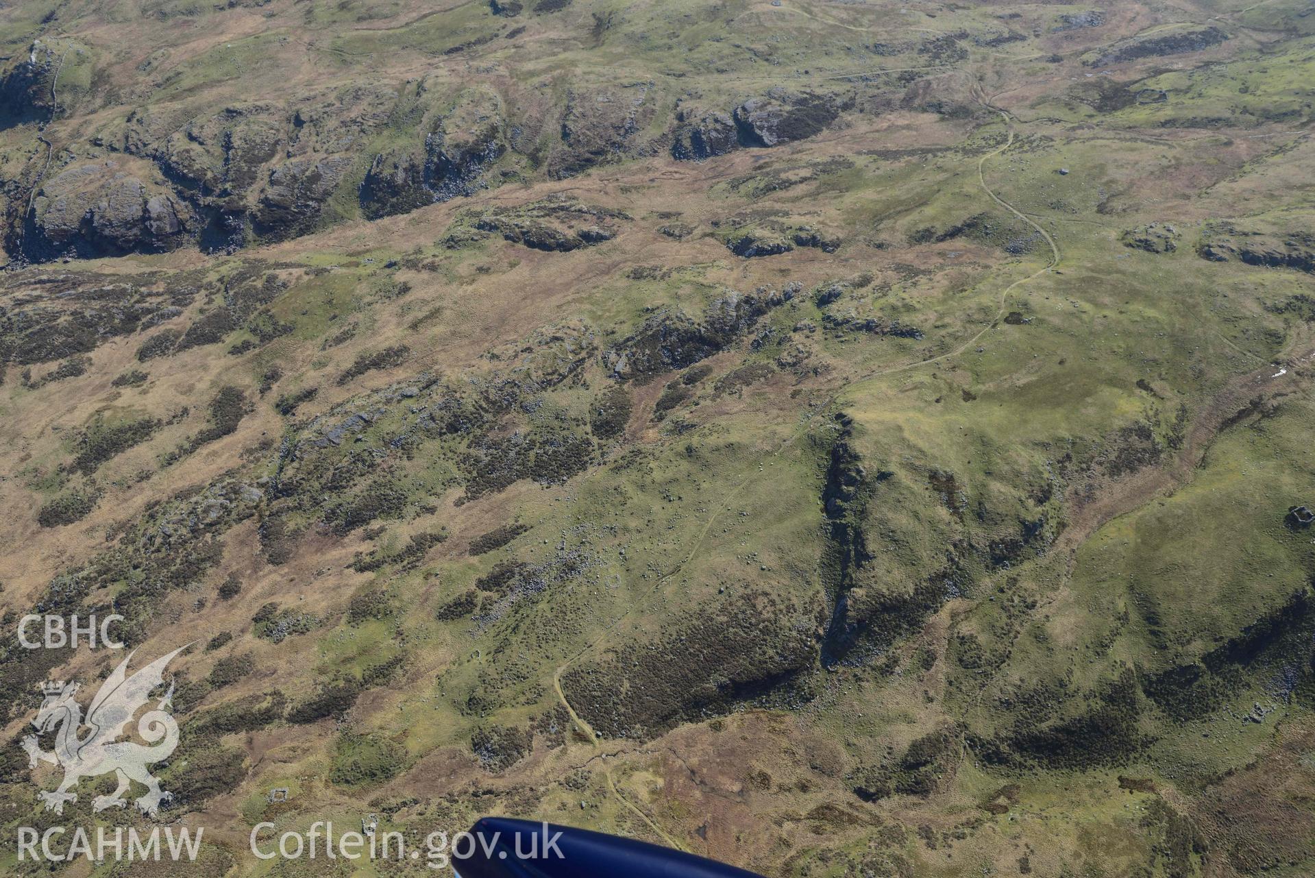 Hut circles east of Moel Geifr, wide landscape view from the north. Oblique aerial photographs taken during the Royal Commission’s programme of archaeological aerial reconnaissance by Toby Driver on 25 March 2022.