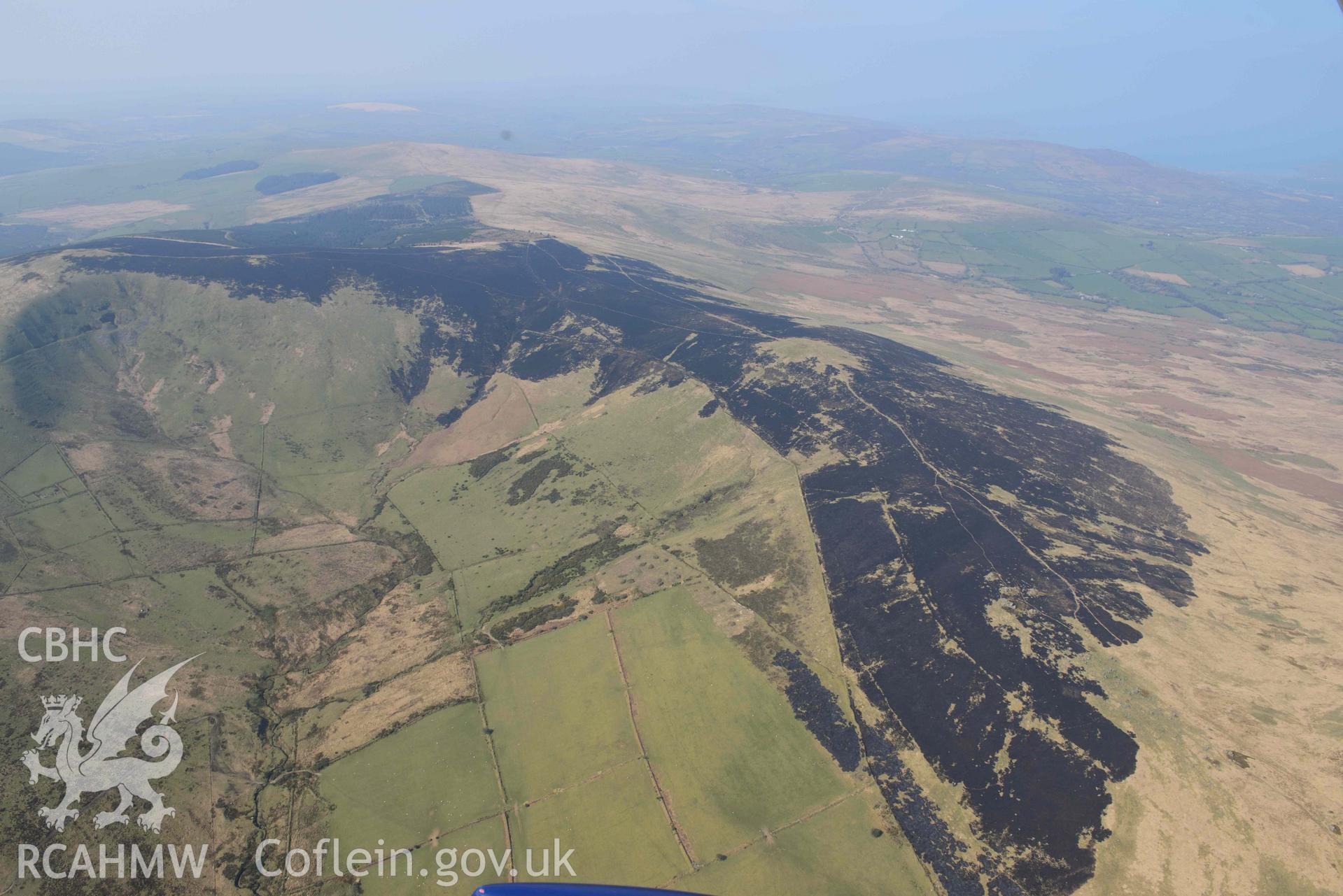 Mynydd Preseli, bracken burn centred on Foel Feddau, view from the east. Oblique aerial photograph taken during the Royal Commission’s programme of archaeological aerial reconnaissance by Toby Driver on 25 March 2022.