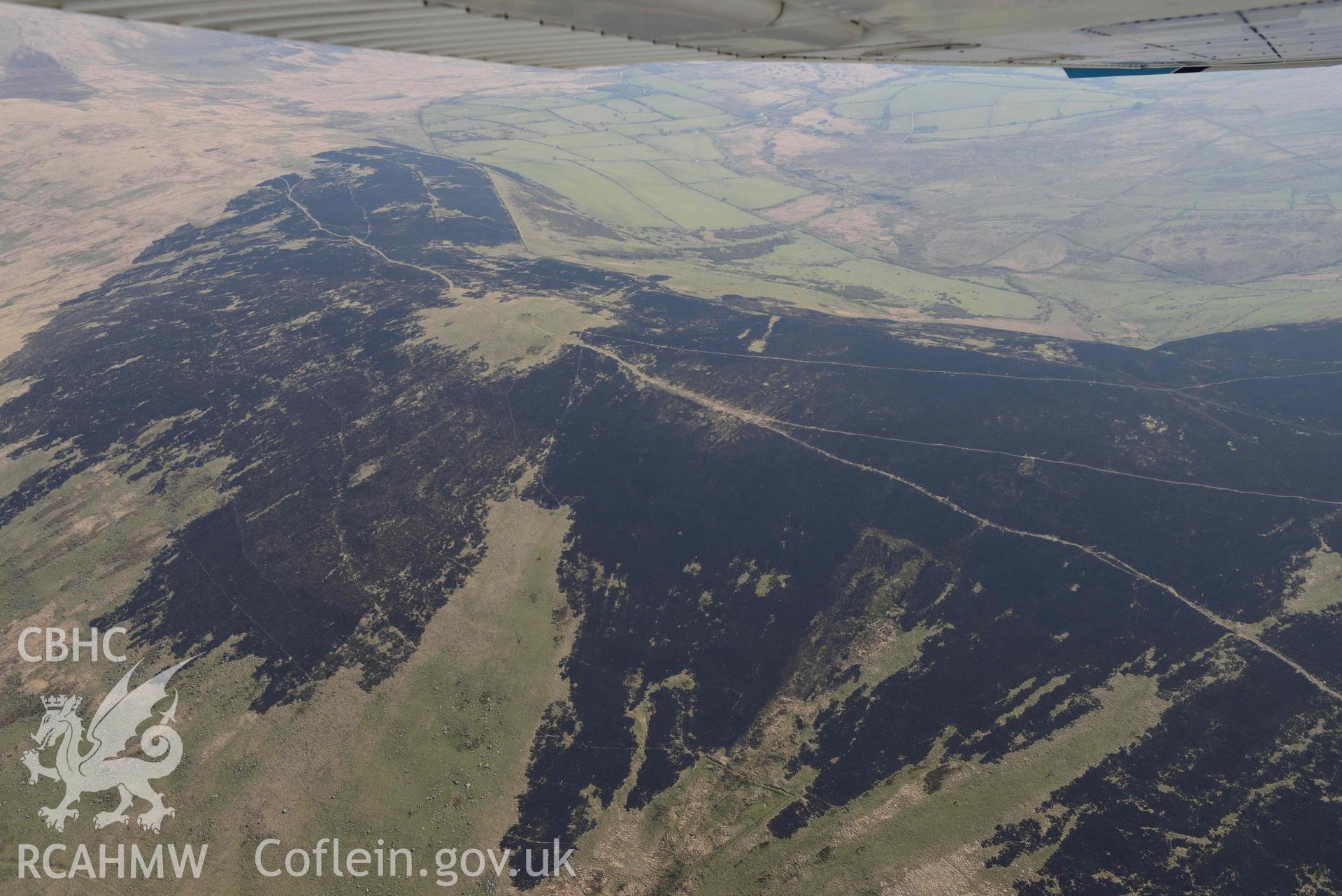 Mynydd Preseli, bracken burn centred on Foel Feddau cairn. Oblique aerial photograph taken during the Royal Commission’s programme of archaeological aerial reconnaissance by Toby Driver on 25 March 2022.