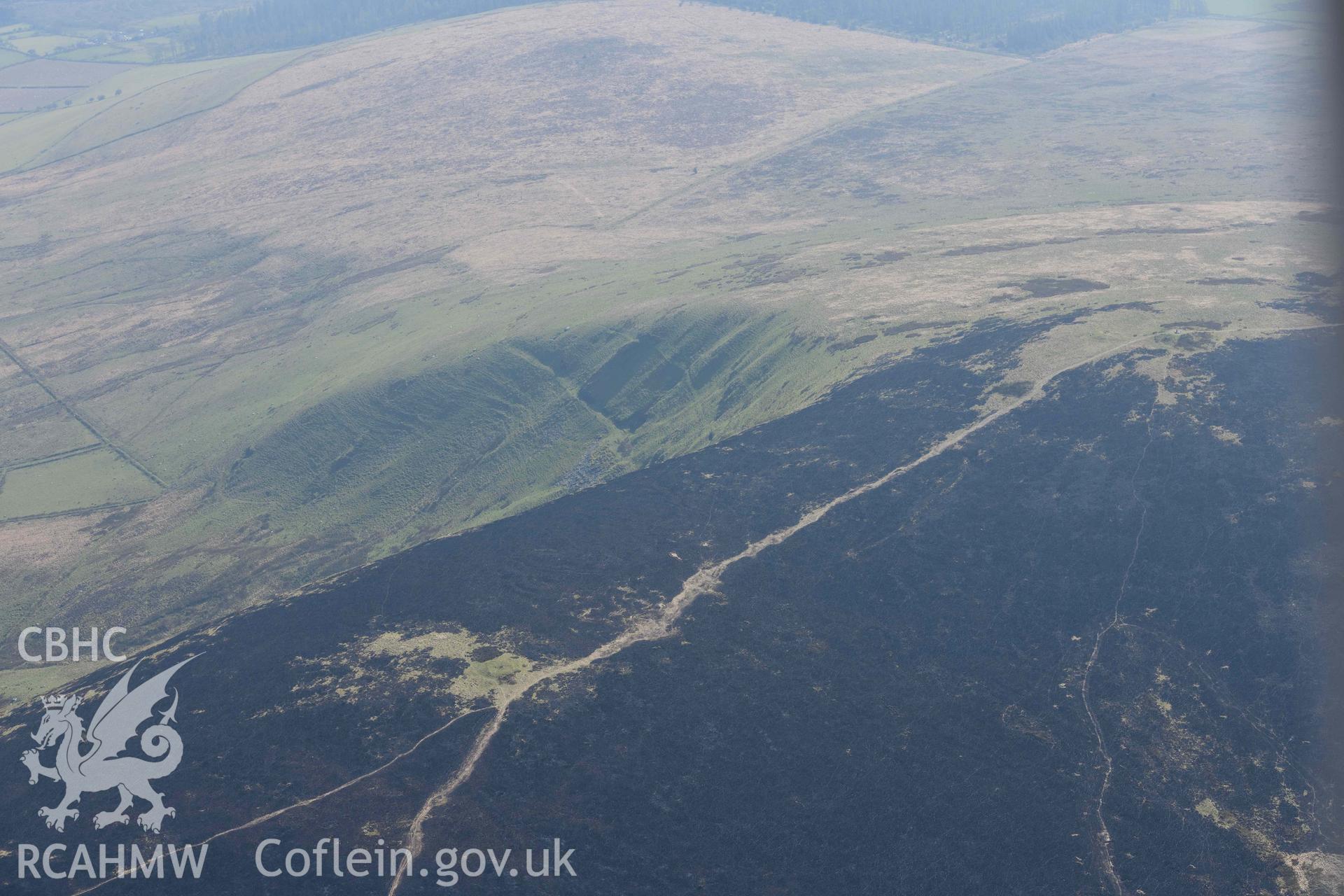 Mynydd Preseli, bracken burn around Foel Cwm-Cerwyn. Oblique aerial photograph taken during the Royal Commission’s programme of archaeological aerial reconnaissance by Toby Driver on 25 March 2022.