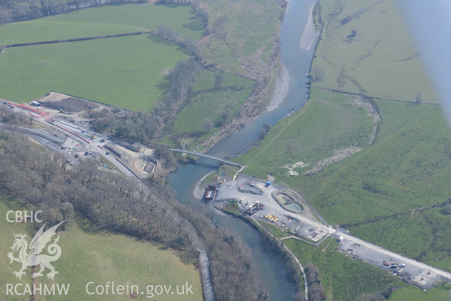 Millennium Bridge, Afon Ddyfi, with the new A487 road bridge under construction. Oblique aerial photograph taken during the Royal Commission’s programme of archaeological aerial reconnaissance by Toby Driver on 25 March 2022.