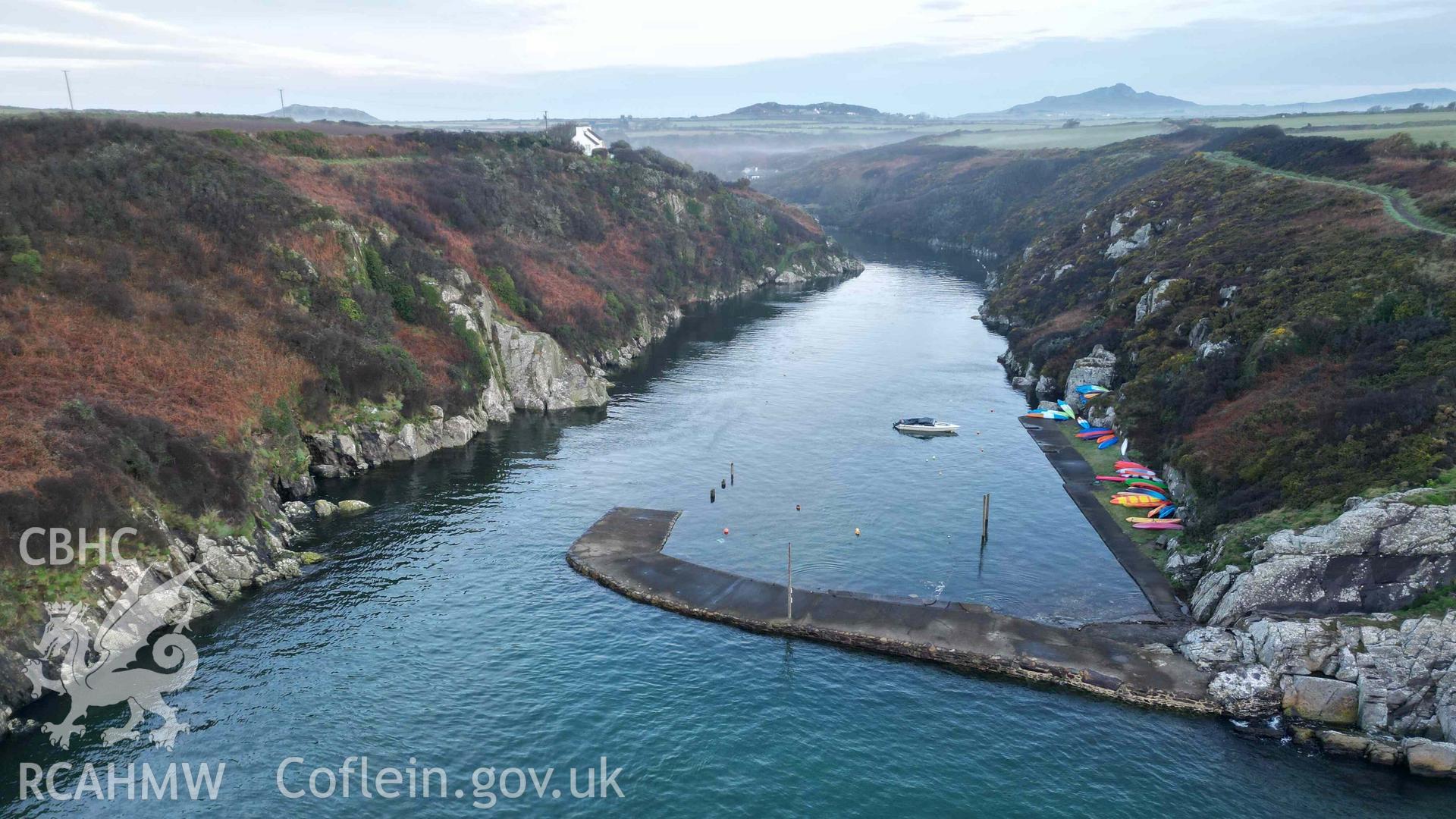 Oblique view of Porthclais Harbour breakwater, from seaward, at high tide on 11 March 2024.