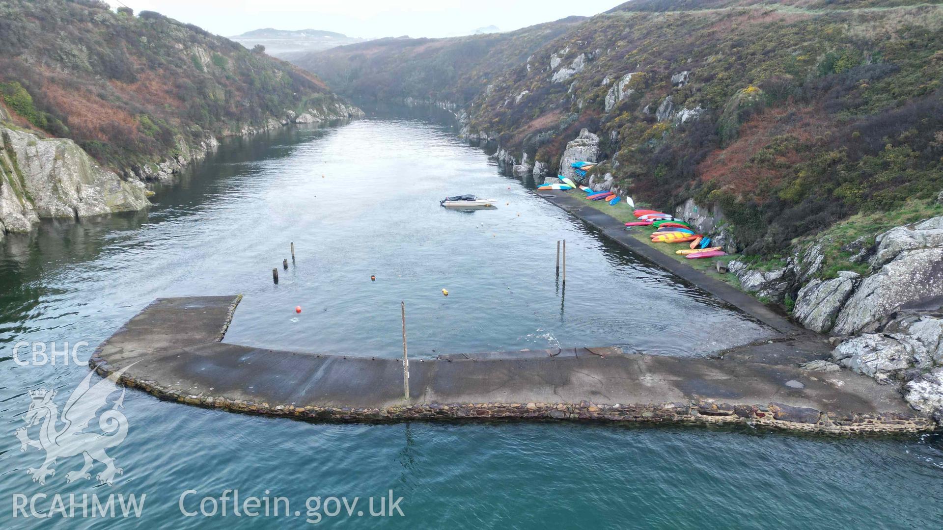 Oblique low-view of Porthclais Harbour breakwater, from seaward, at high tide on 11 March 2024.