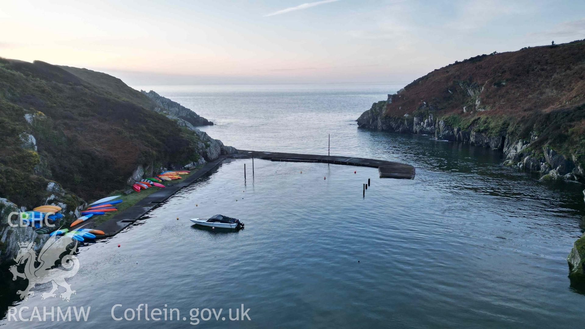 Oblique view of Porthclais Harbour breakwater, looking seaward, at high tide on 11 March 2024.