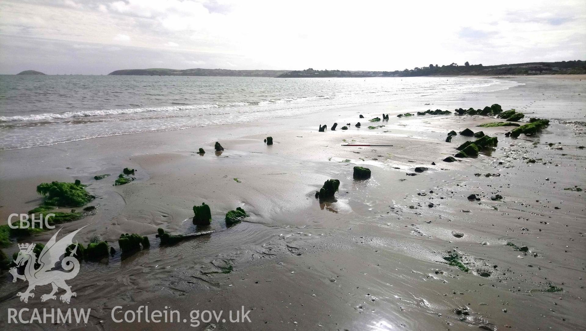 The wreck, looking southwest.  Stern to right. Part of photographic survey of the Unnamed Wreck (Fosil?) on The Warren Beach, Abersoch, conducted on 11 September 2018 by Daniel Hunt. Crown Copyright. CHERISH project. Produced with EU funds through the Ireland Wales Co-operation Programme 2014-2023. All material made freely available through the Open Government Licence.