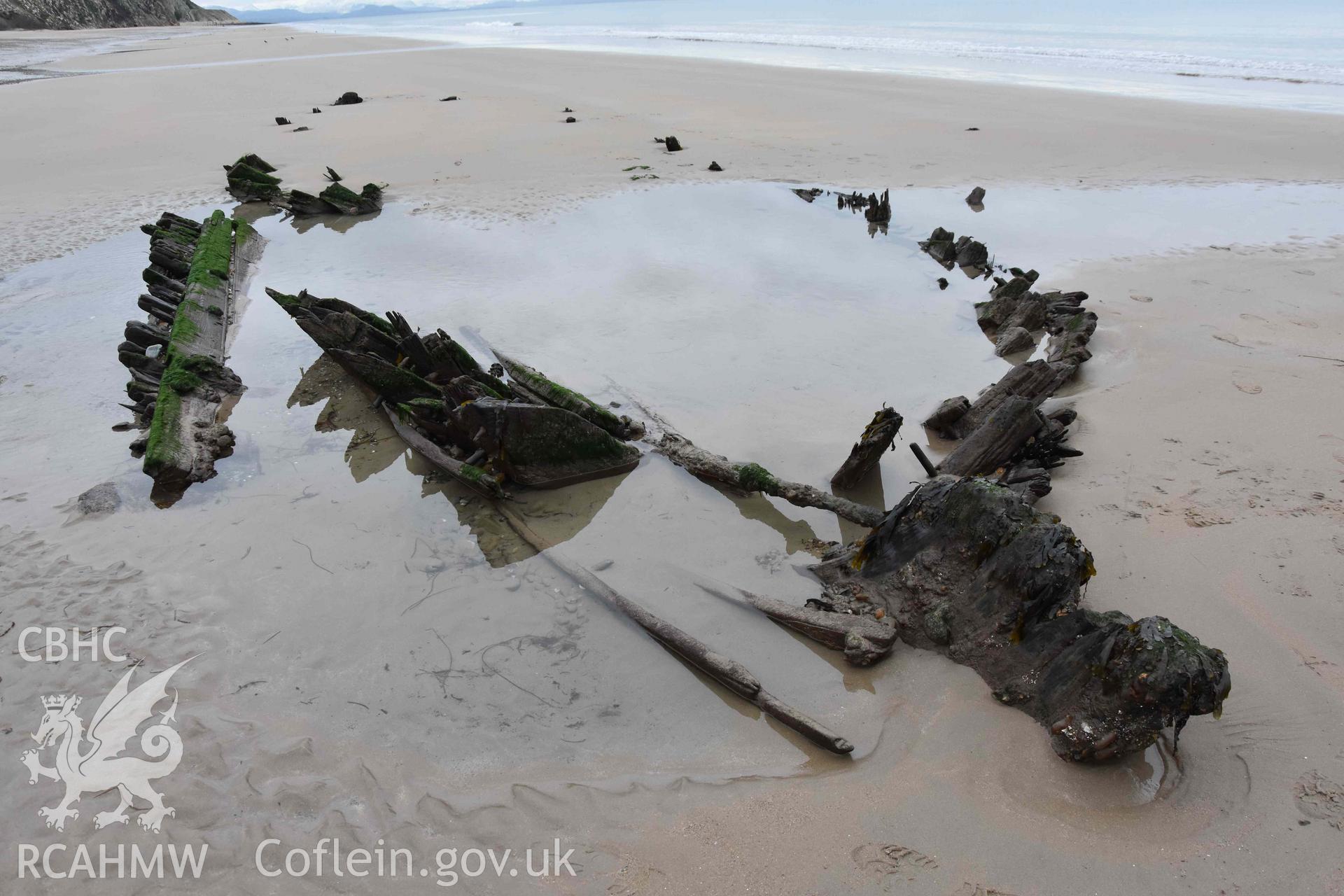 The wreck, looking northeast. Stern in foreground. Digital photograph of the Unnamed Wreck (Fosil?) on The Warren Beach, Abersoch, taken by Louise Barker on 23 January 2019. Crown Copyright. CHERISH project. Produced with EU funds through the Ireland Wales Co-operation Programme 2014-2023. All material made freely available through the Open Government Licence.