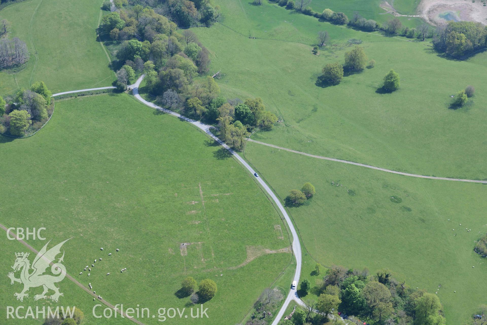 Dinefwr Park Prisoner of War camp, visible as parchmarks. Oblique aerial photograph taken during the Royal Commission's programme of archaeological aerial reconnaissance by Toby Driver on 29 April 2022.