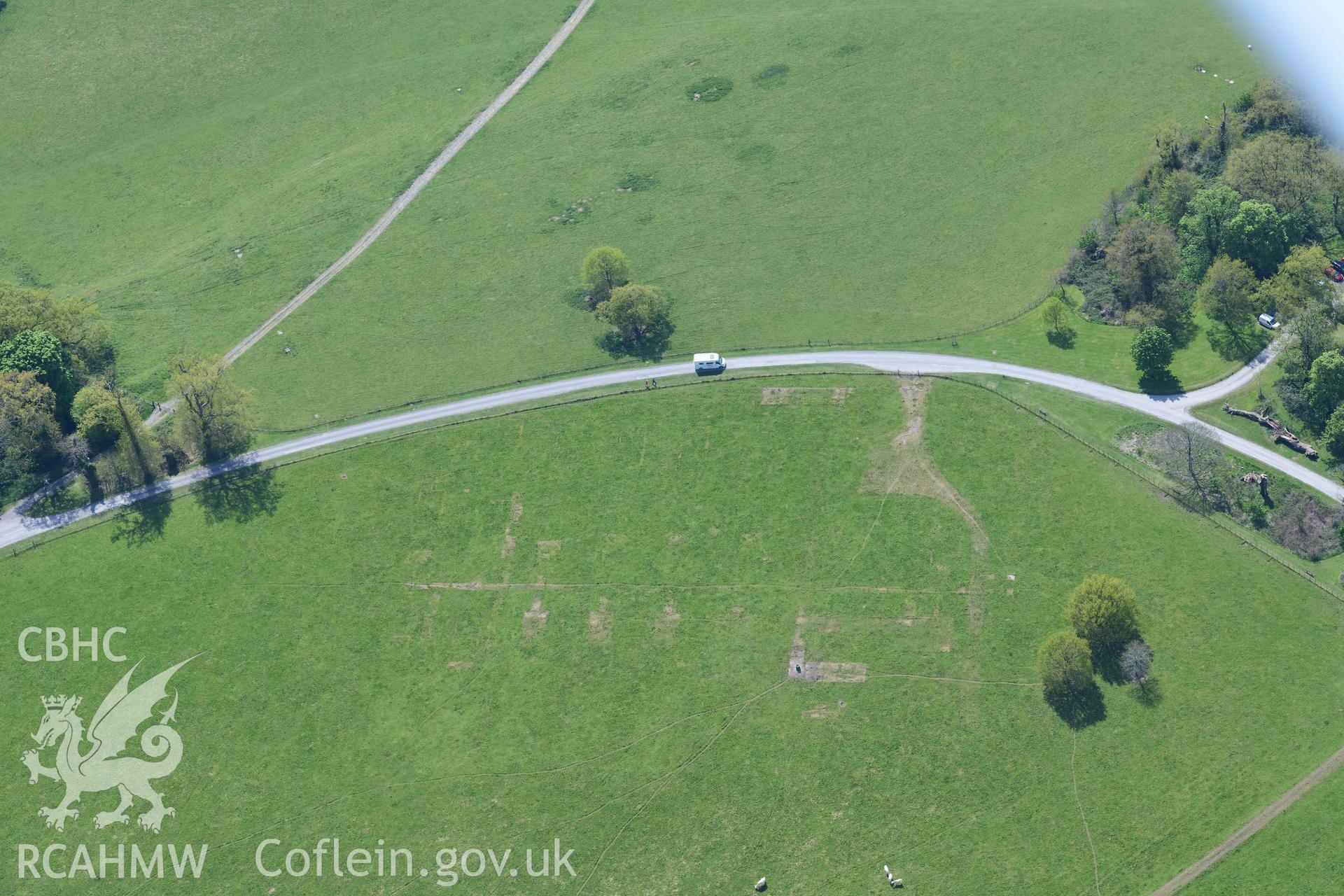 Dinefwr Park Prisoner of War camp, visible as parchmarks. Oblique aerial photograph taken during the Royal Commission's programme of archaeological aerial reconnaissance by Toby Driver on 29 April 2022.