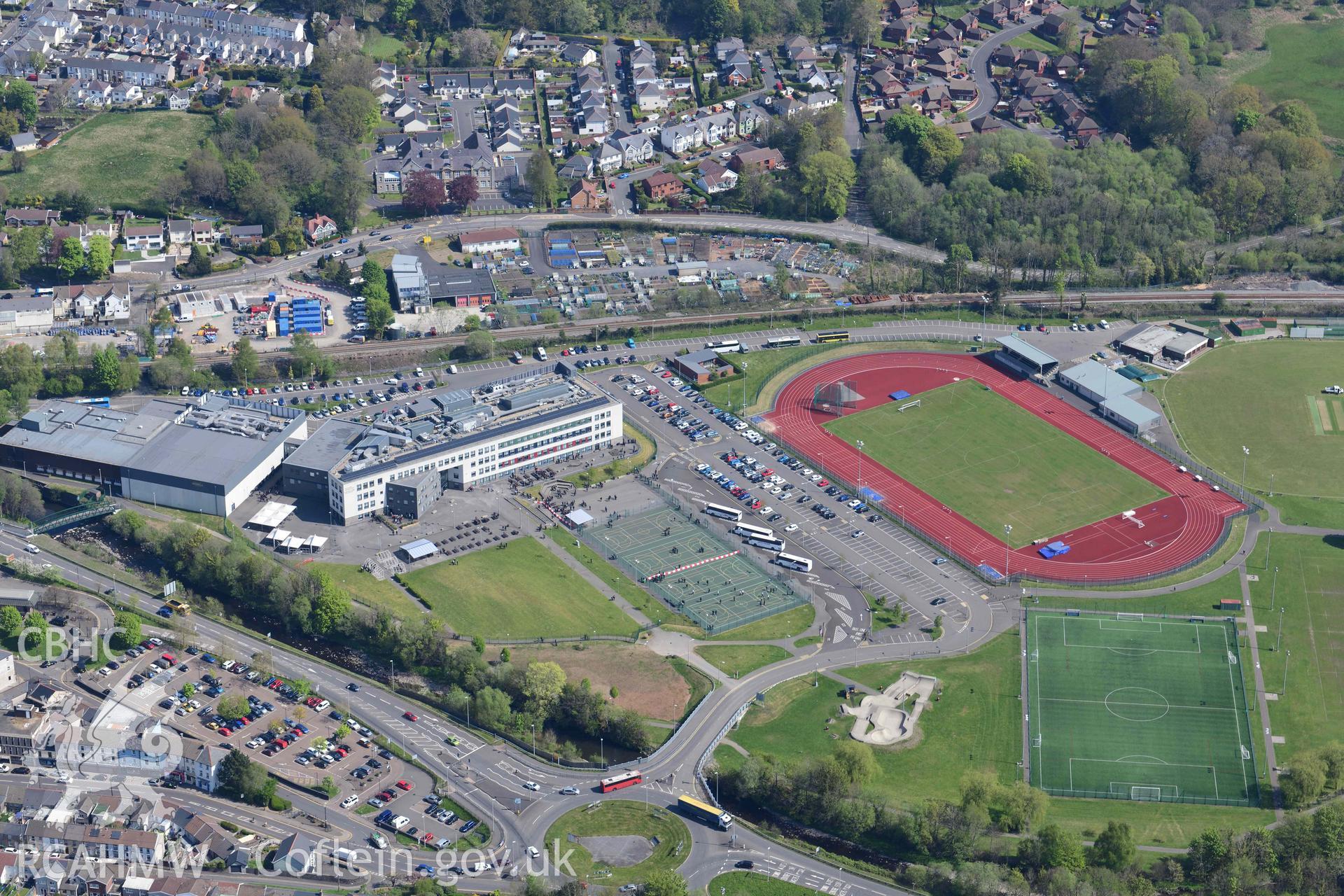 Ynys Stadium, Aberdare, with school. Oblique aerial photograph taken during the Royal Commission's programme of archaeological aerial reconnaissance by Toby Driver on 29 April 2022.