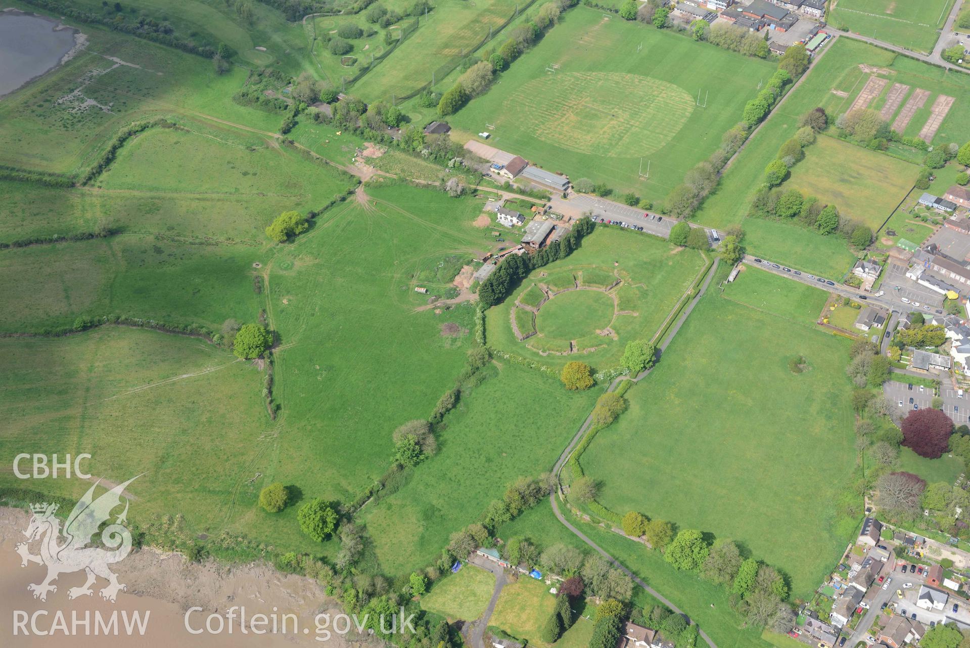 Caerleon Amphitheatre and the south western part of fortress. Oblique aerial photograph taken during the Royal Commission's programme of archaeological aerial reconnaissance by Toby Driver on 29 April 2022.