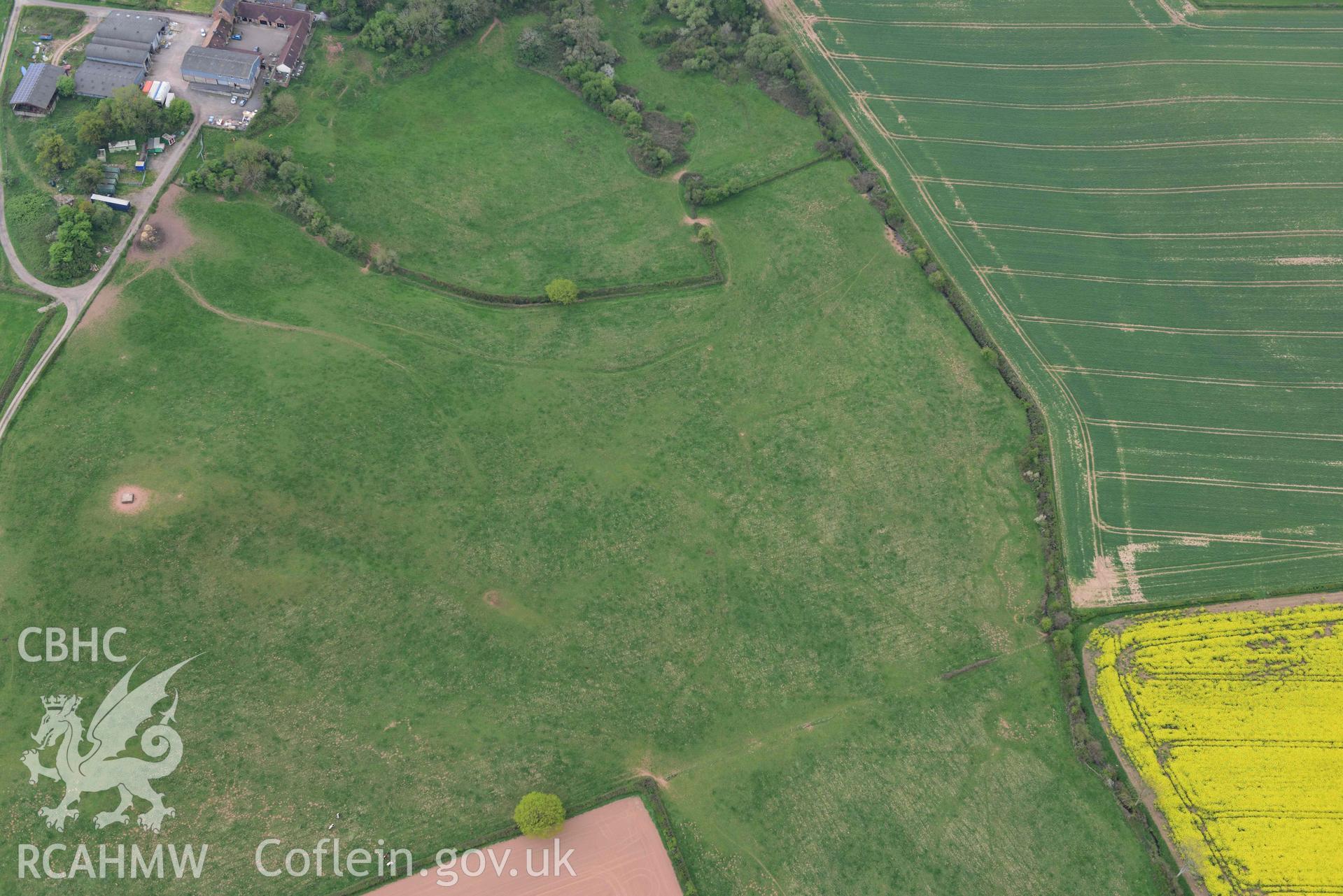 Raglan Castle siegework; earthworks to the north west. Oblique aerial photograph taken during the Royal Commission's programme of archaeological aerial reconnaissance by Toby Driver on 29 April 2022.