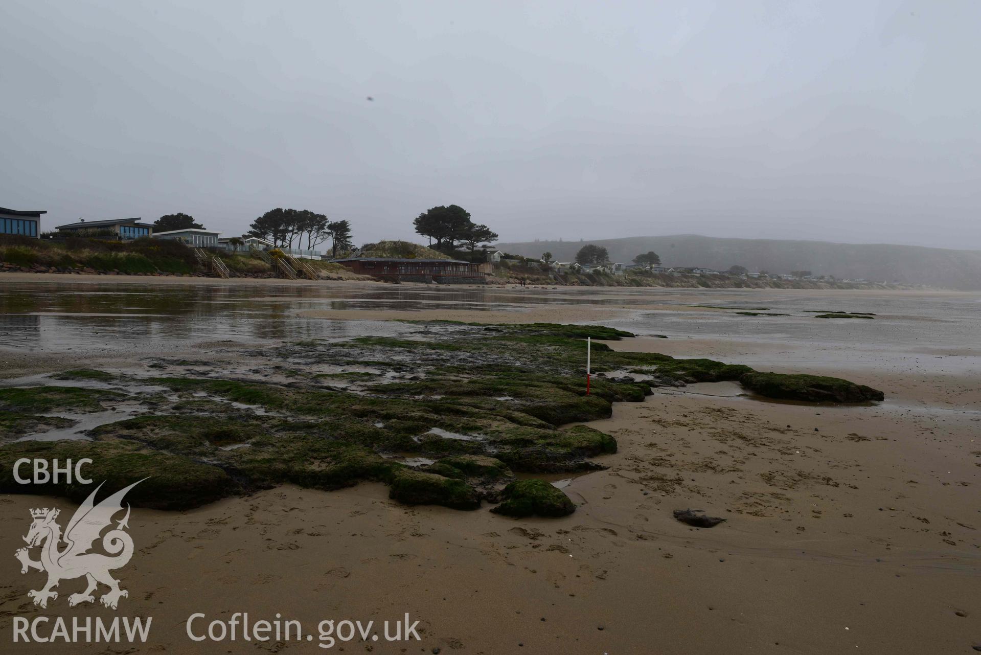 Peat exposure. View looking northeast. Part of survey of the Submerged Forest, Peat Exposures and Footprints on The Warren Beach, Abersoch, conducted by Toby Driver on 29 March 2021. Produced with EU funds through the Ireland Wales Co-operation Programme 2014-2023. All material made freely available through the Open Government Licence.