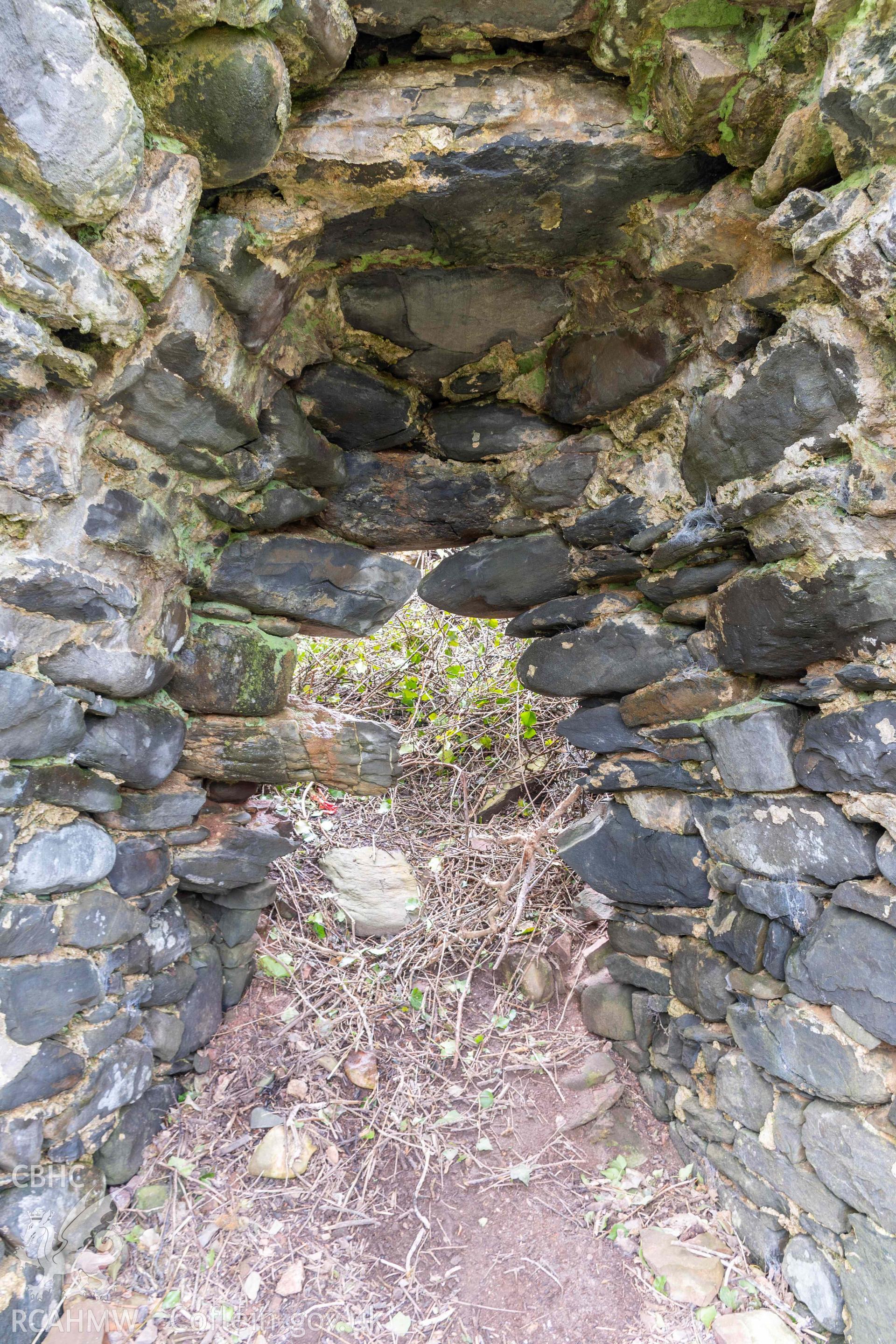 Kiln 1, collapse at rear of kiln-eye into crucible, east elevation. Part of photographic survey of Aberstrincell lime kilns and coal yard, conducted by Louise Barker of the RCAHMW survey team on 21 March 2024.