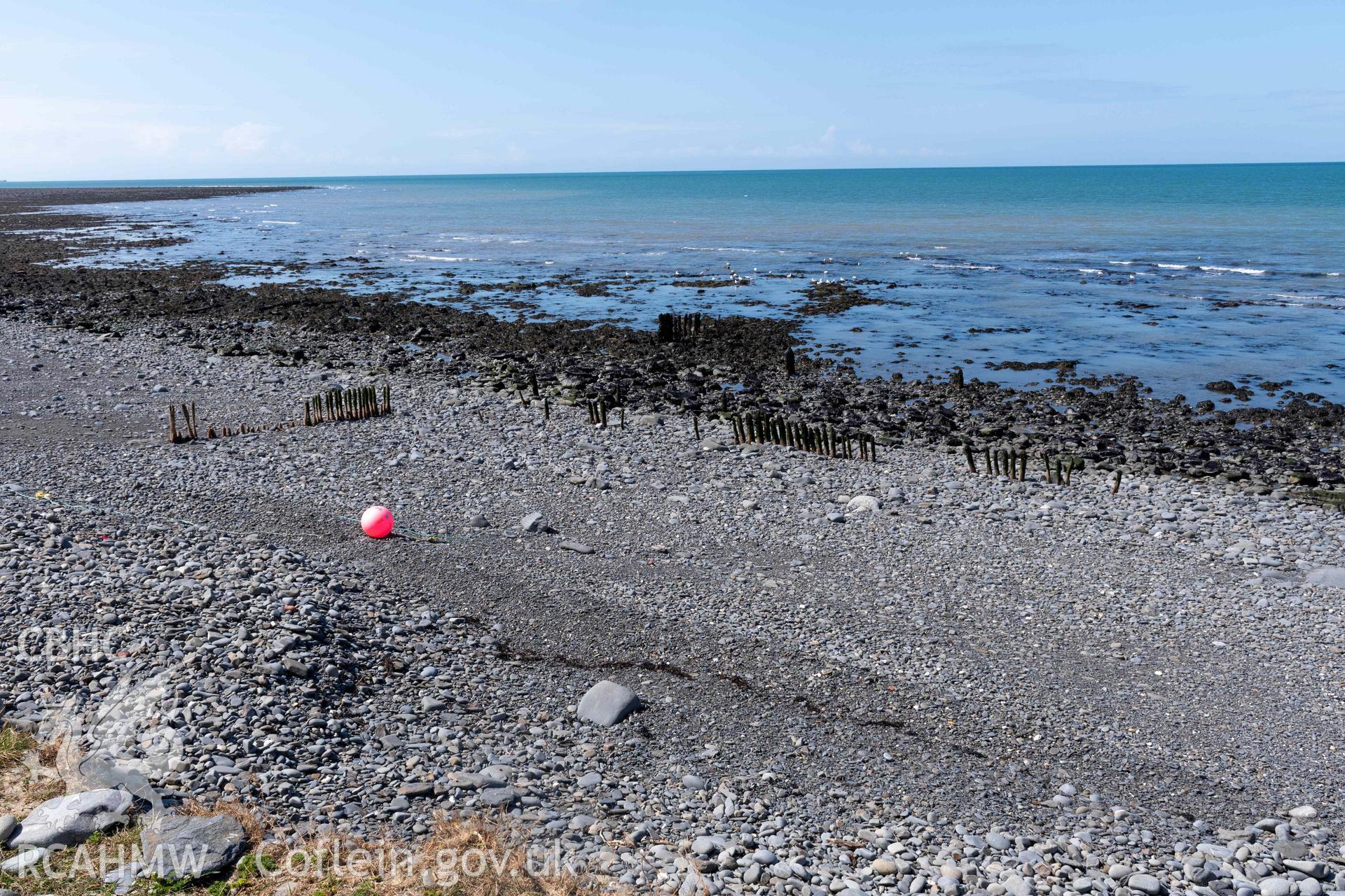 Groyne (SN5213968609) and Jetty (SN5214268626), Aberstrincell, looking west. Part of photographic survey of Aberstrincell lime kilns and coal yard, conducted by Louise Barker of the RCAHMW survey team on 21 March 2024.