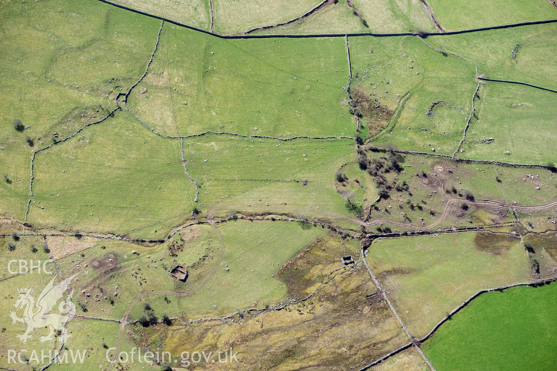 Moel Faban early field system, hut group, view from north. Oblique aerial photograph taken during the Royal Commission’s programme of archaeological aerial reconnaissance by Toby Driver on 20 April 2018.