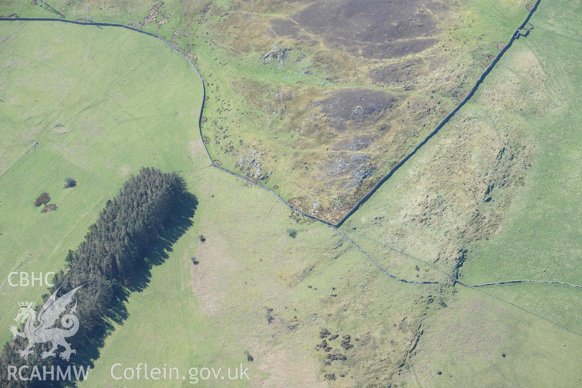 Enclosed hut group, Cae'r Mynydd, view from north. Oblique aerial photograph taken during the Royal Commission’s programme of archaeological aerial reconnaissance by Toby Driver on 20 April 2018.