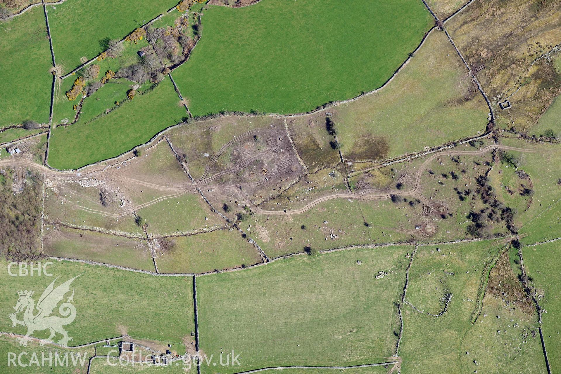 Llanllechid, enclosed hut group, with vehicle damage. Oblique aerial photograph taken during the Royal Commission’s programme of archaeological aerial reconnaissance by Toby Driver on 20 April 2018.