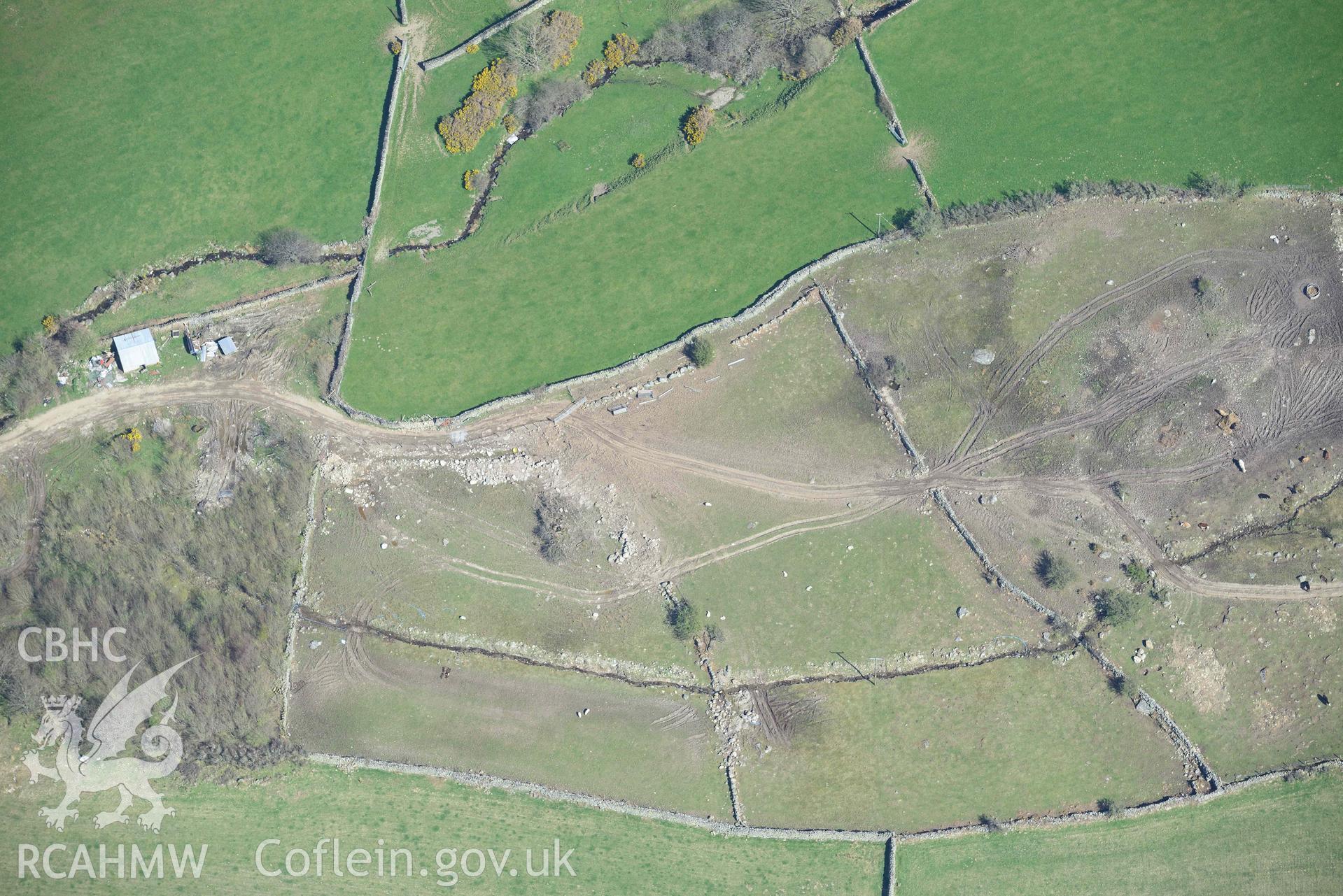 Llanllechid, enclosed hut group, with vehicle damage. Oblique aerial photograph taken during the Royal Commission’s programme of archaeological aerial reconnaissance by Toby Driver on 20 April 2018.