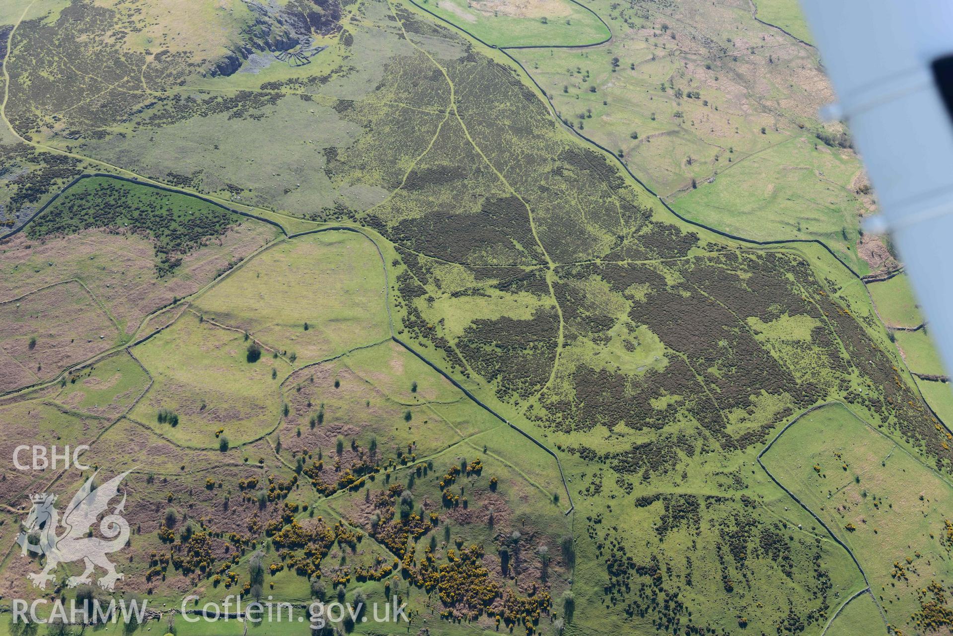 Garreg Fawr enclosed settlement and field systems, view from north. Oblique aerial photograph taken during the Royal Commission’s programme of archaeological aerial reconnaissance by Toby Driver on 20 April 2018.