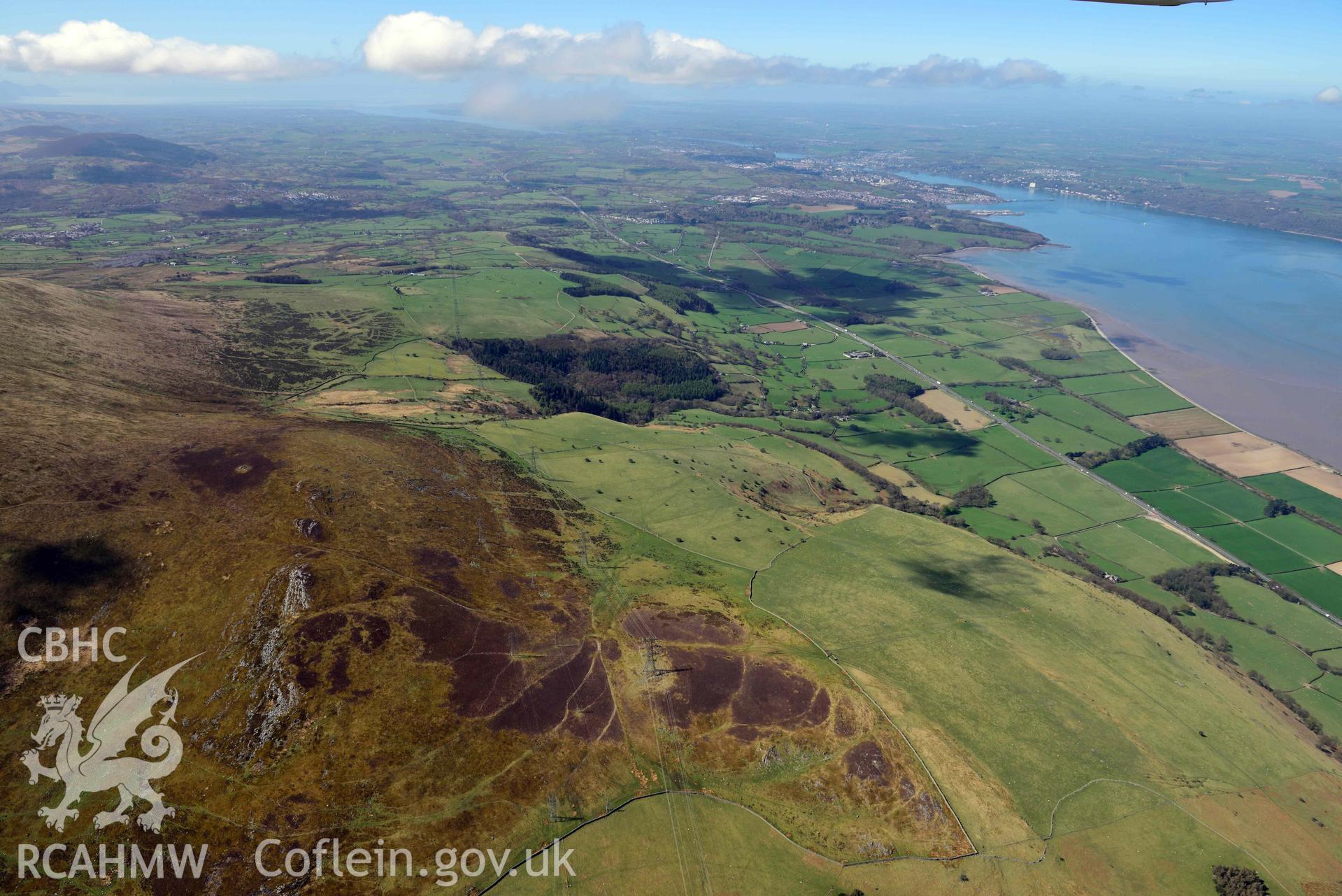 Ffridd ddu field system, wide landscape looking west towards Bangor. Oblique aerial photograph taken during the Royal Commission’s programme of archaeological aerial reconnaissance by Toby Driver on 20 April 2018.