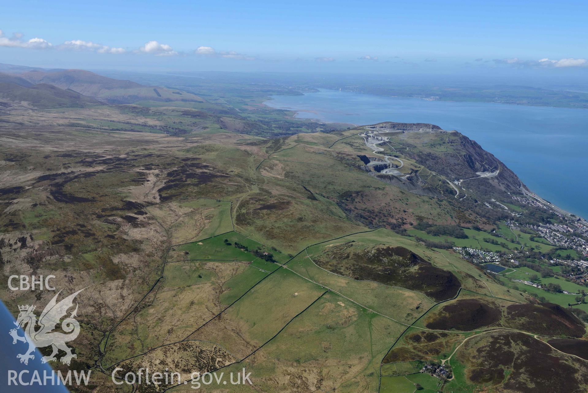 Braich y Dinas hillfort (site of), landscape view from south-east. Oblique aerial photograph taken during the Royal Commission’s programme of archaeological aerial reconnaissance by Toby Driver on 20 April 2018.