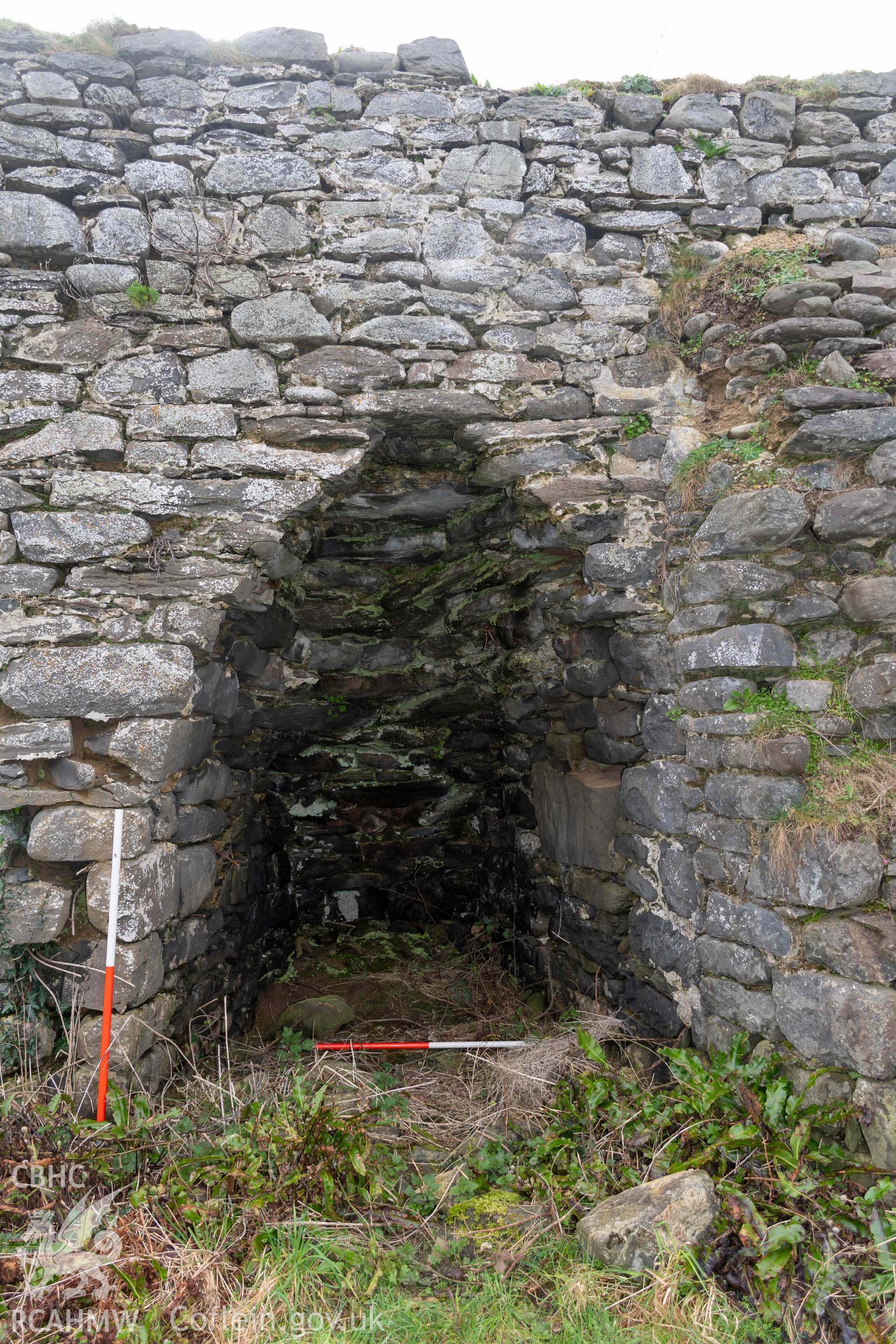 Kiln 3, kiln-eye, north elevation (with scale). Part of photographic survey of Aberstrincell lime kilns and coal yard, conducted by Louise Barker of the RCAHMW survey team on 21 March 2024.