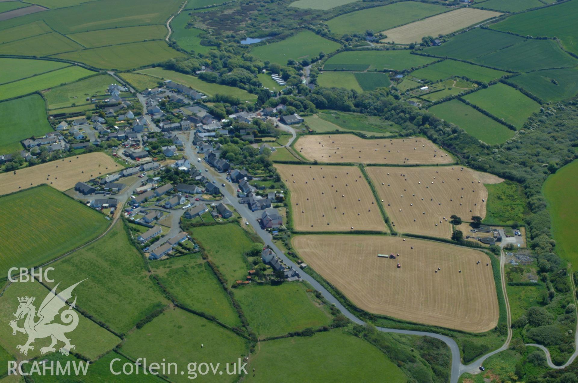 RCAHMW colour oblique aerial photograph of Trefin Chapel (Welsh Calvinistic Methodist) and Trefin Village in landscape view from the east. Taken on 25 May 2004 by Toby Driver