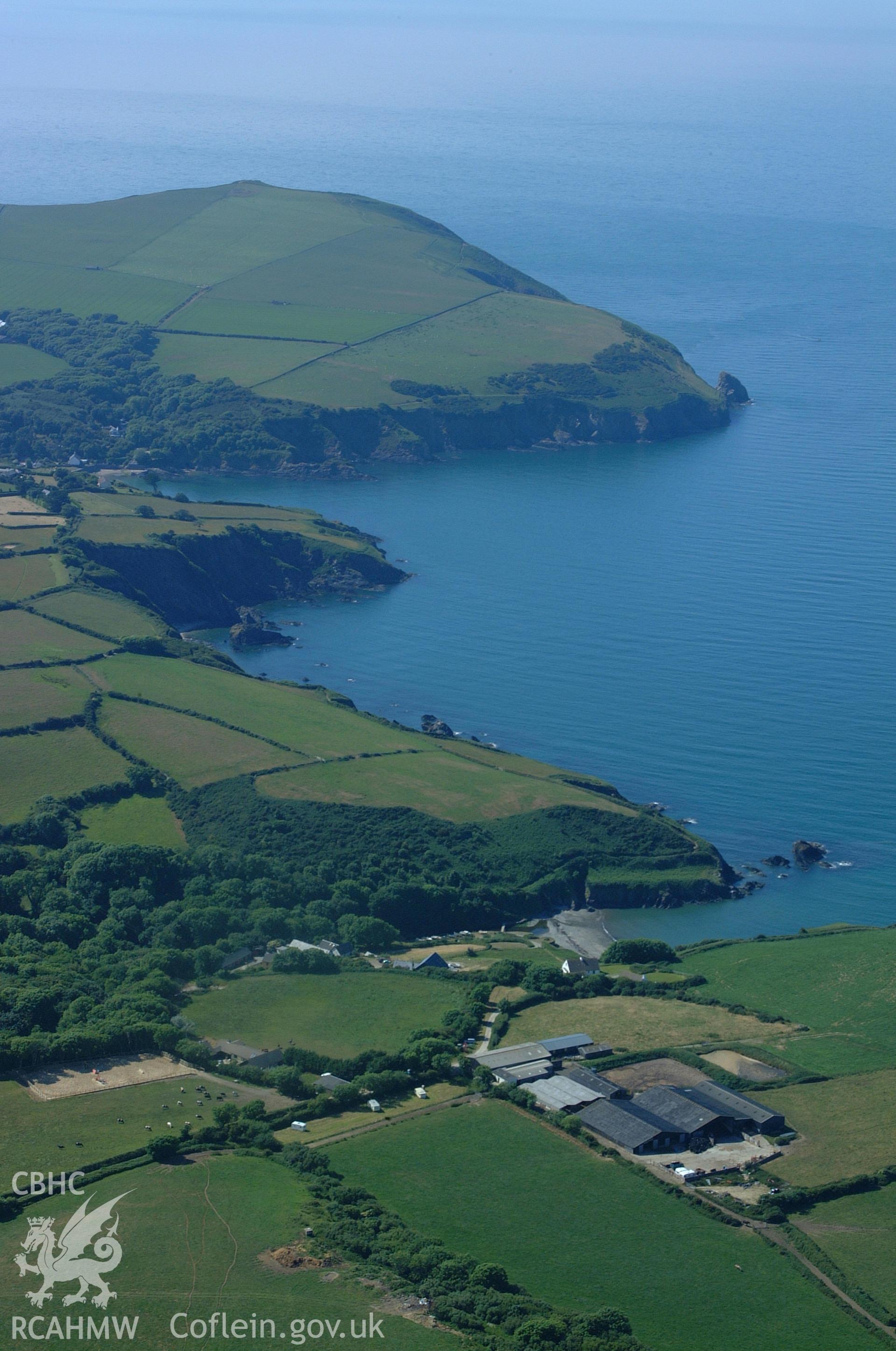 RCAHMW colour oblique aerial photograph of Dinas harbour and Cwm-yr-eglwys taken on 15/06/2004 by Toby Driver