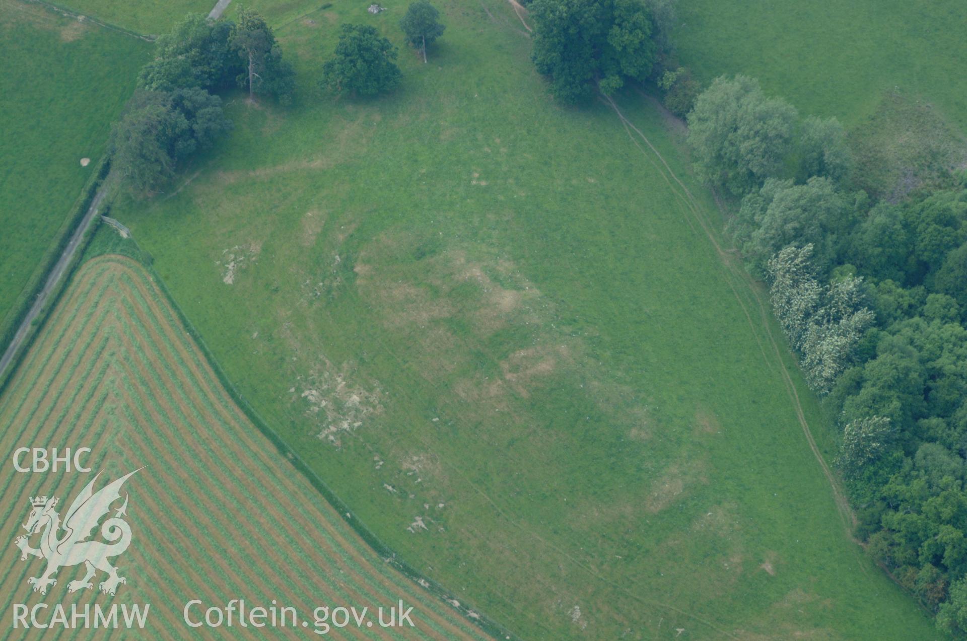 RCAHMW colour oblique aerial photograph of Plas Uchaf Enclosure taken on 08/06/2004 by Toby Driver