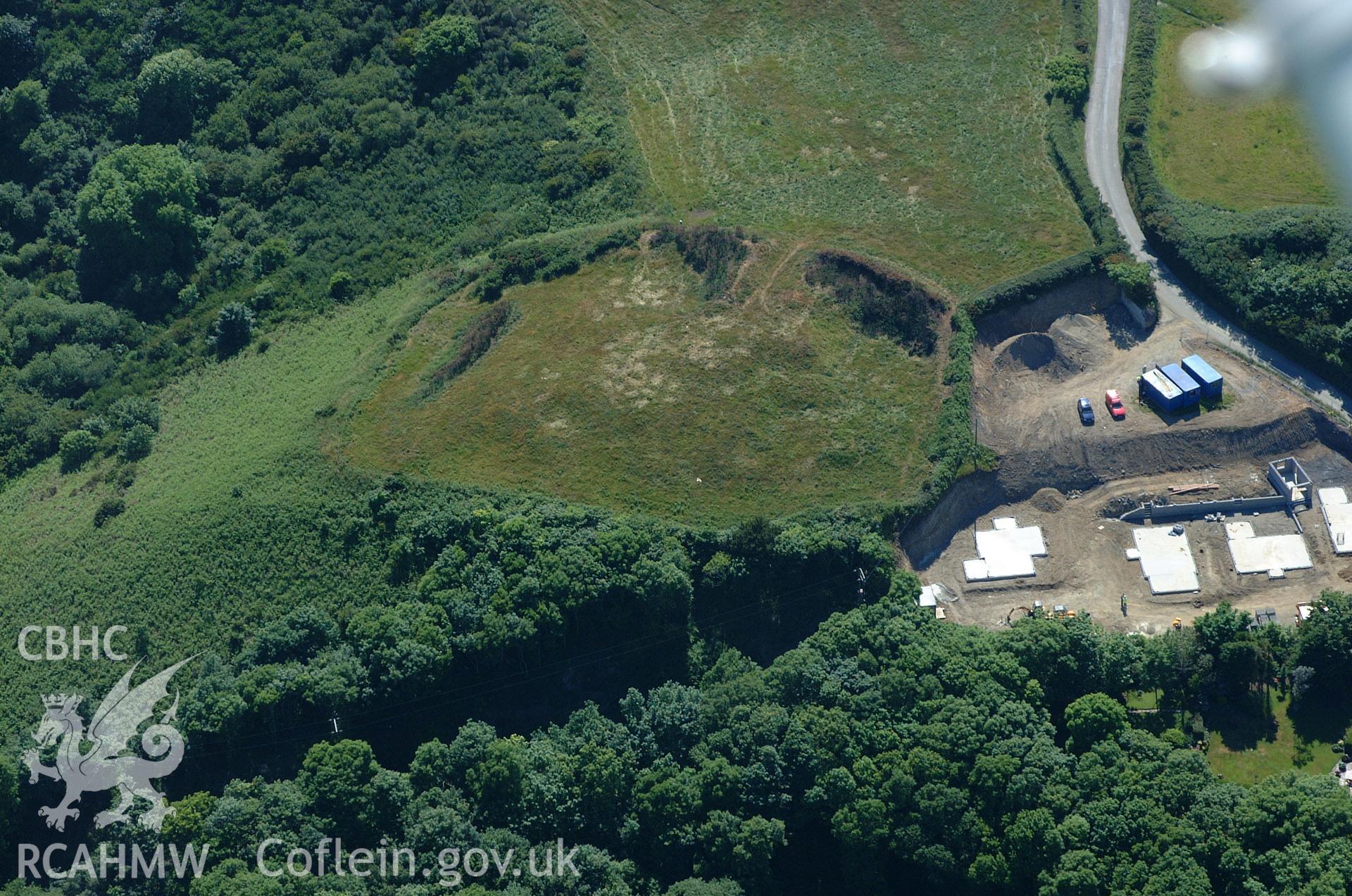 RCAHMW colour oblique aerial photograph of Strawberry Hill Enclosure showing the adjacent development. Taken on 15 June 2004 by Toby Driver